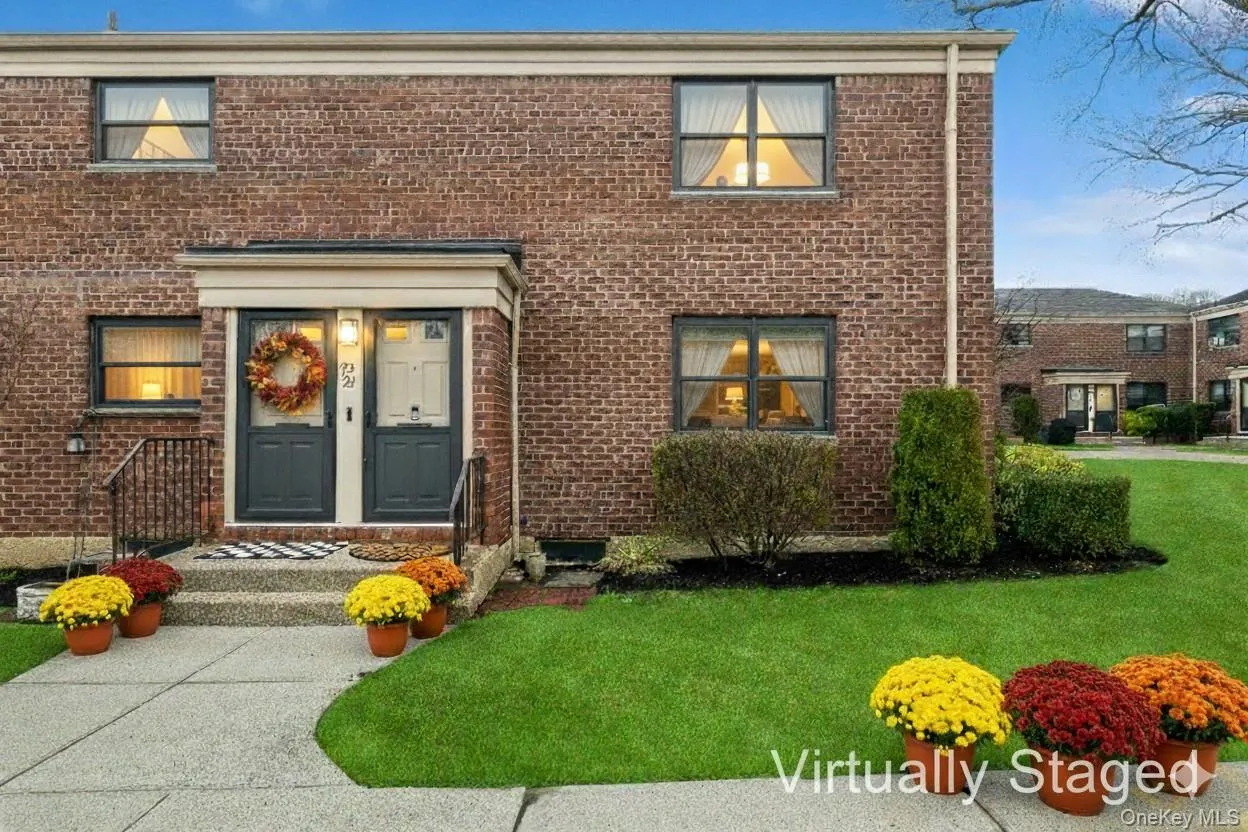 View of front facade featuring brick siding and a front lawn View of front facade featuring brick siding and a front lawn