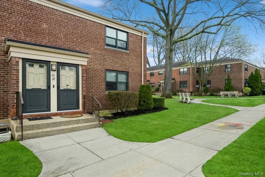 Doorway to property with brick siding and a lawn Doorway to property with brick siding and a lawn