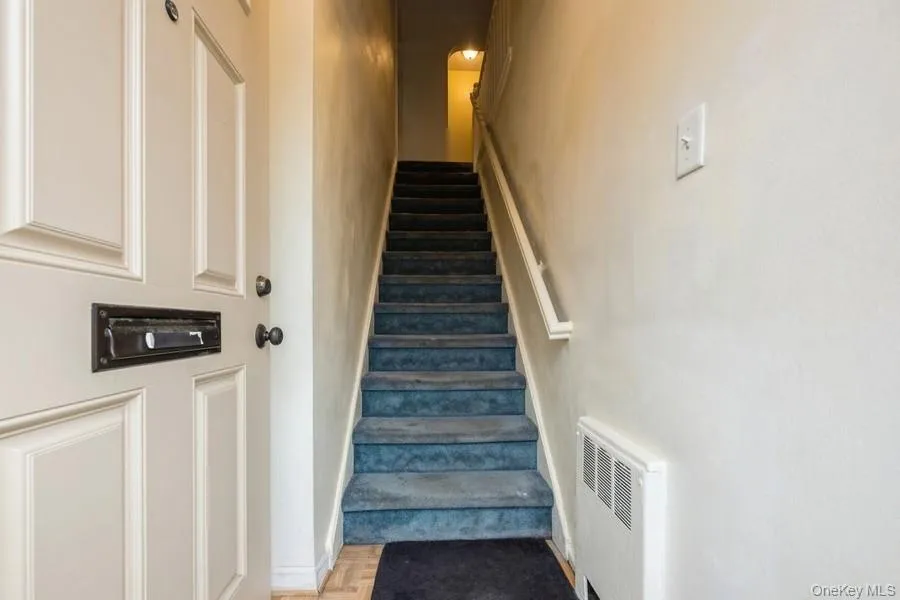 Stairway featuring radiator heating unit Stairway featuring radiator heating unit