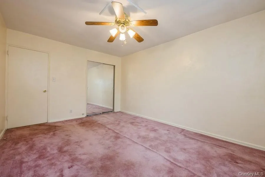 Unfurnished bedroom featuring ceiling fan, a closet, and carpet Unfurnished bedroom featuring ceiling fan, a closet, and carpet