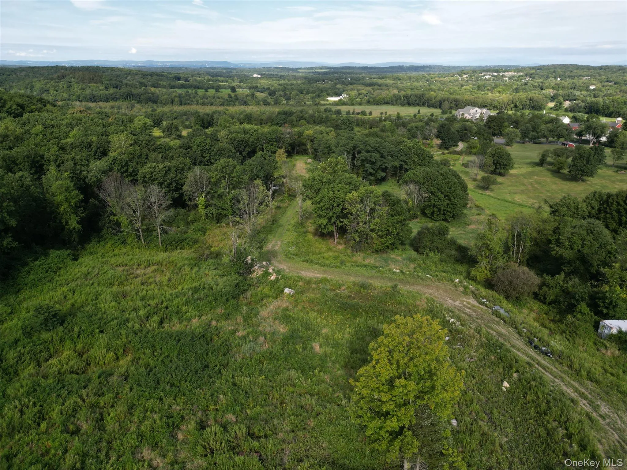 View of property location with a heavily wooded area View of property location with a heavily wooded area