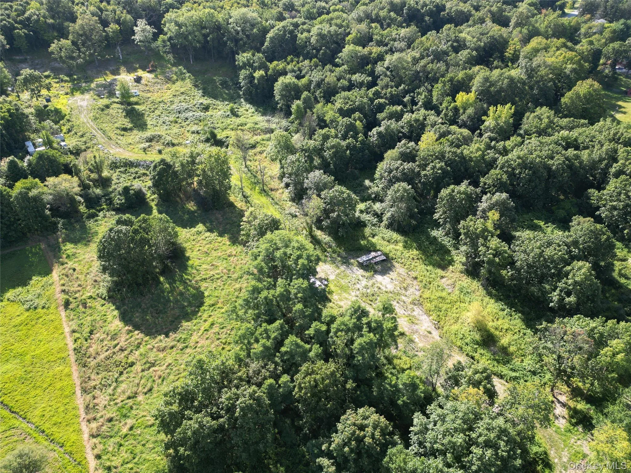 Aerial overview of property's location featuring property parcel outlined and a forest Aerial overview of property's location featuring property parcel outlined and a forest