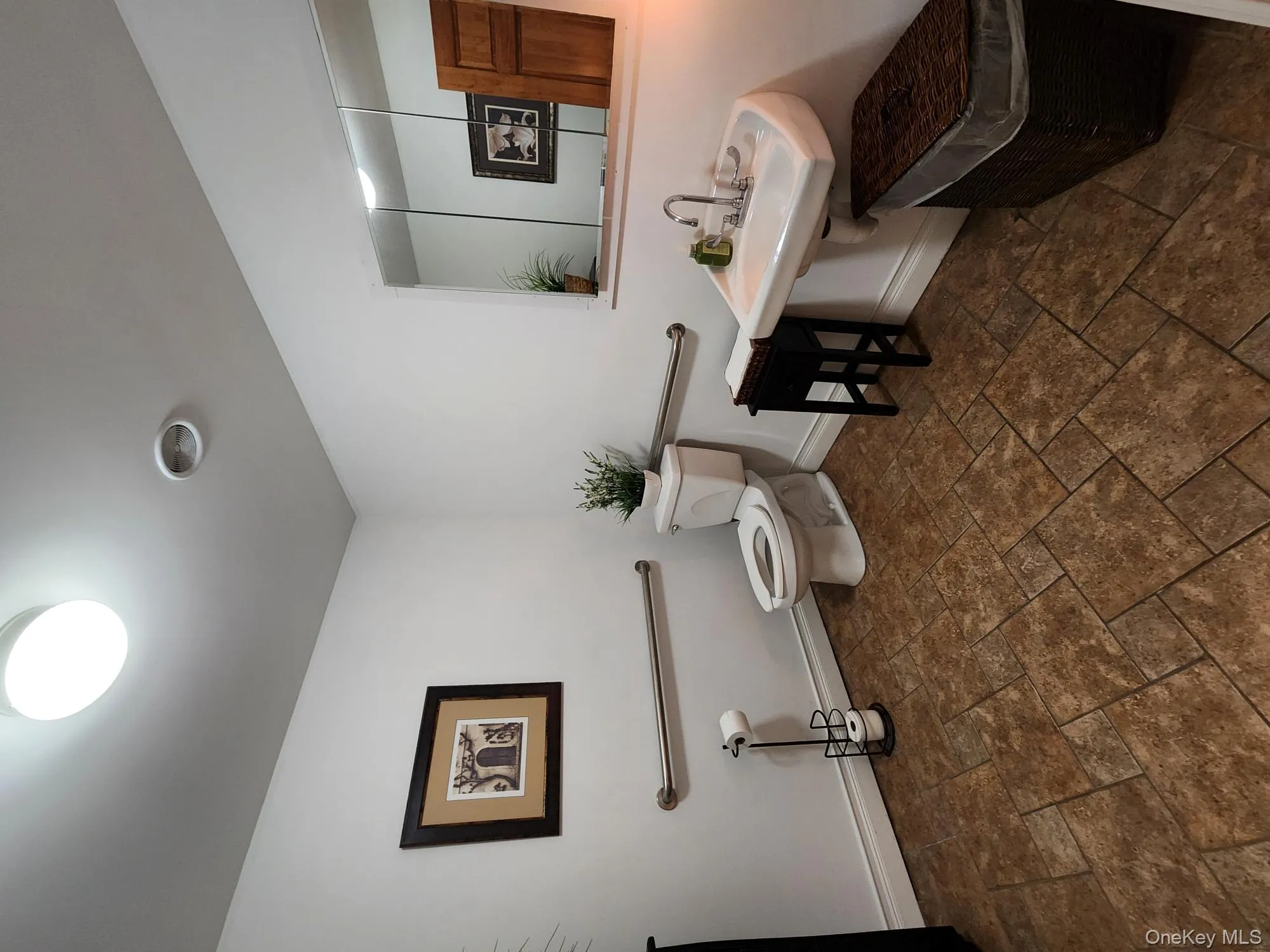 Bathroom featuring dark stone finish floors Bathroom featuring dark stone finish floors