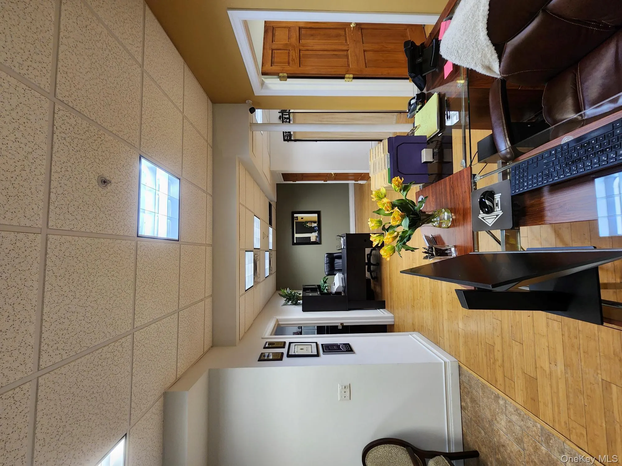 Dining room with an office area, a paneled ceiling, and hardwood / wood-style floors Dining room with an office area, a paneled ceiling, and hardwood / wood-style floors
