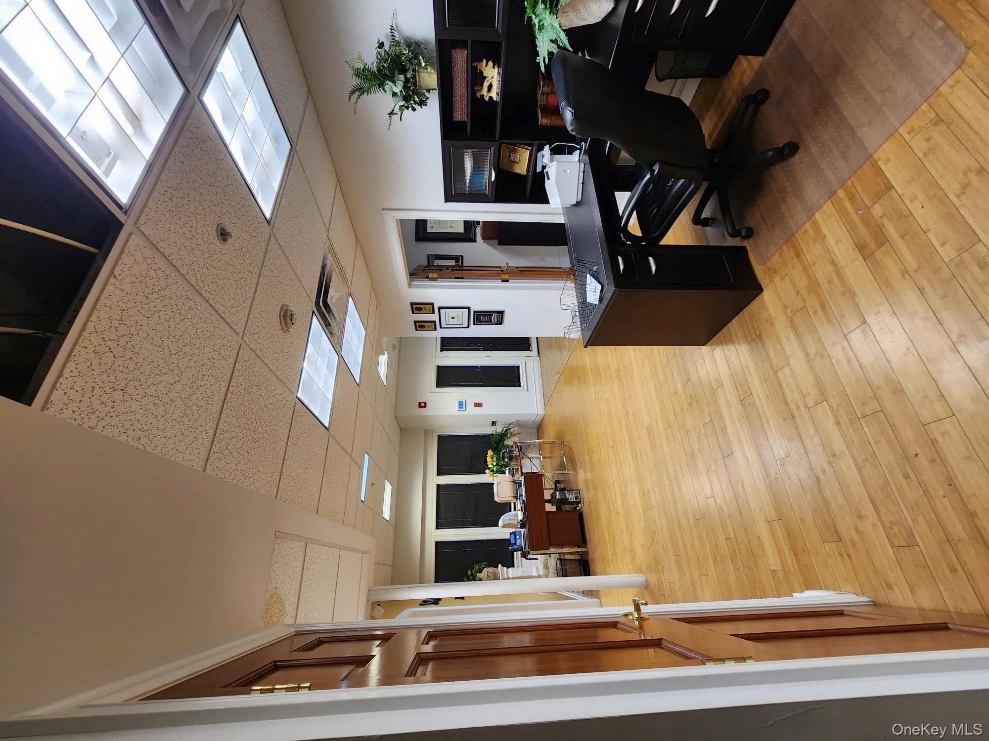 Office area featuring a paneled ceiling and light wood finished floors Office area featuring a paneled ceiling and light wood finished floors