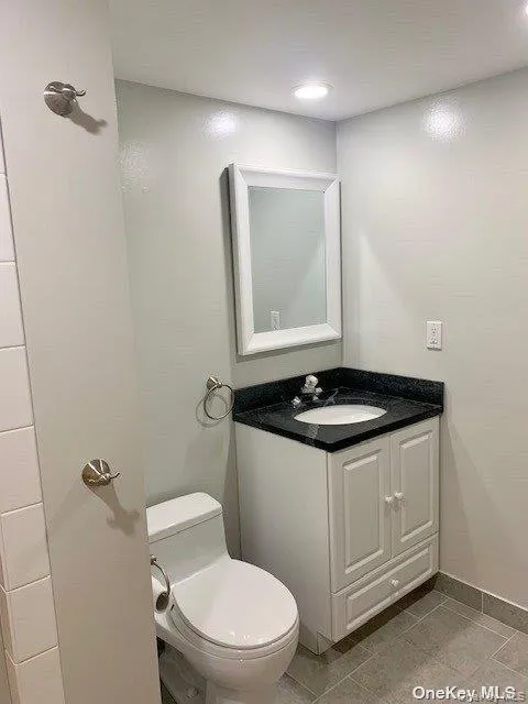Bathroom featuring vanity and light tile patterned floors Bathroom featuring vanity and light tile patterned floors