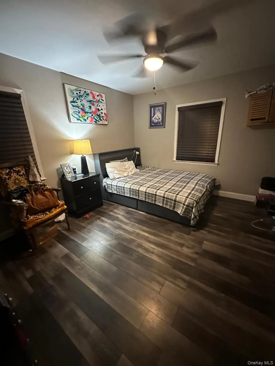 Bedroom with dark wood finished floors and ceiling fan Bedroom with dark wood finished floors and ceiling fan