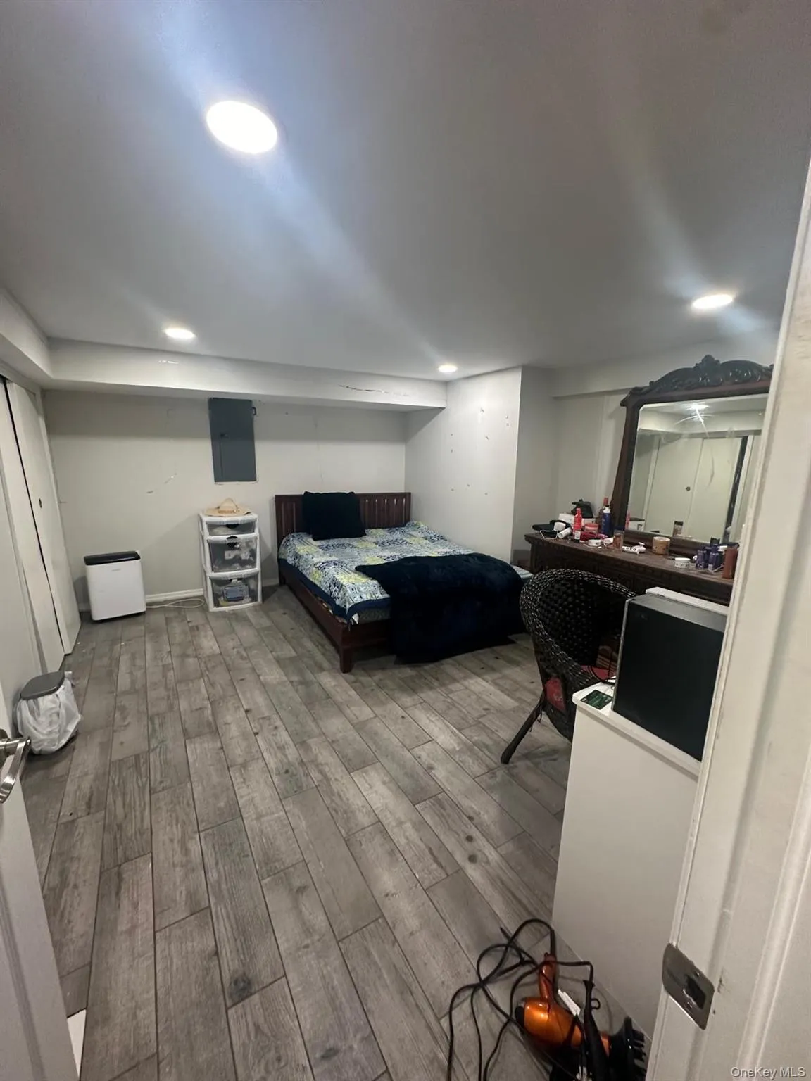 Bedroom with wood finished floors, recessed lighting, and electric panel Bedroom with wood finished floors, recessed lighting, and electric panel
