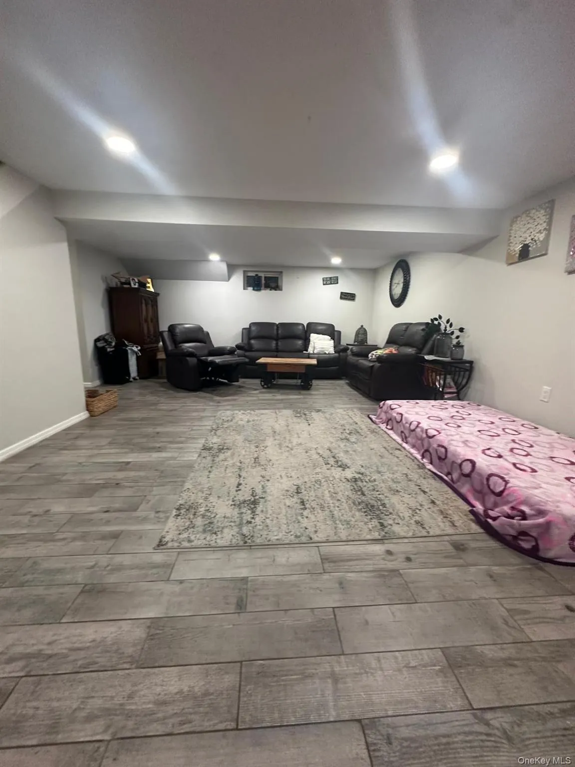 Finished below grade area featuring baseboards and wood finished floors Finished below grade area featuring baseboards and wood finished floors