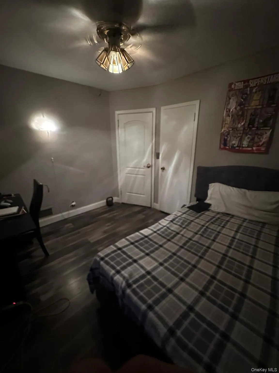 Bedroom with dark wood-style flooring and ceiling fan Bedroom with dark wood-style flooring and ceiling fan