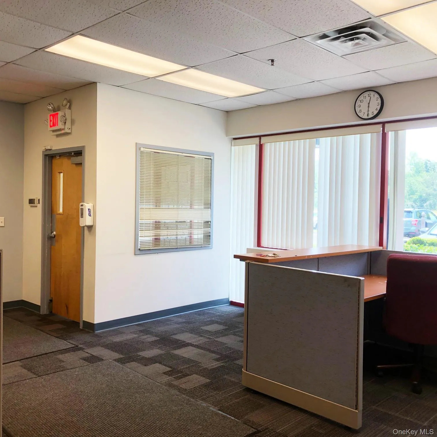 Unfurnished office featuring dark colored carpet and a paneled ceiling Unfurnished office featuring dark colored carpet and a paneled ceiling