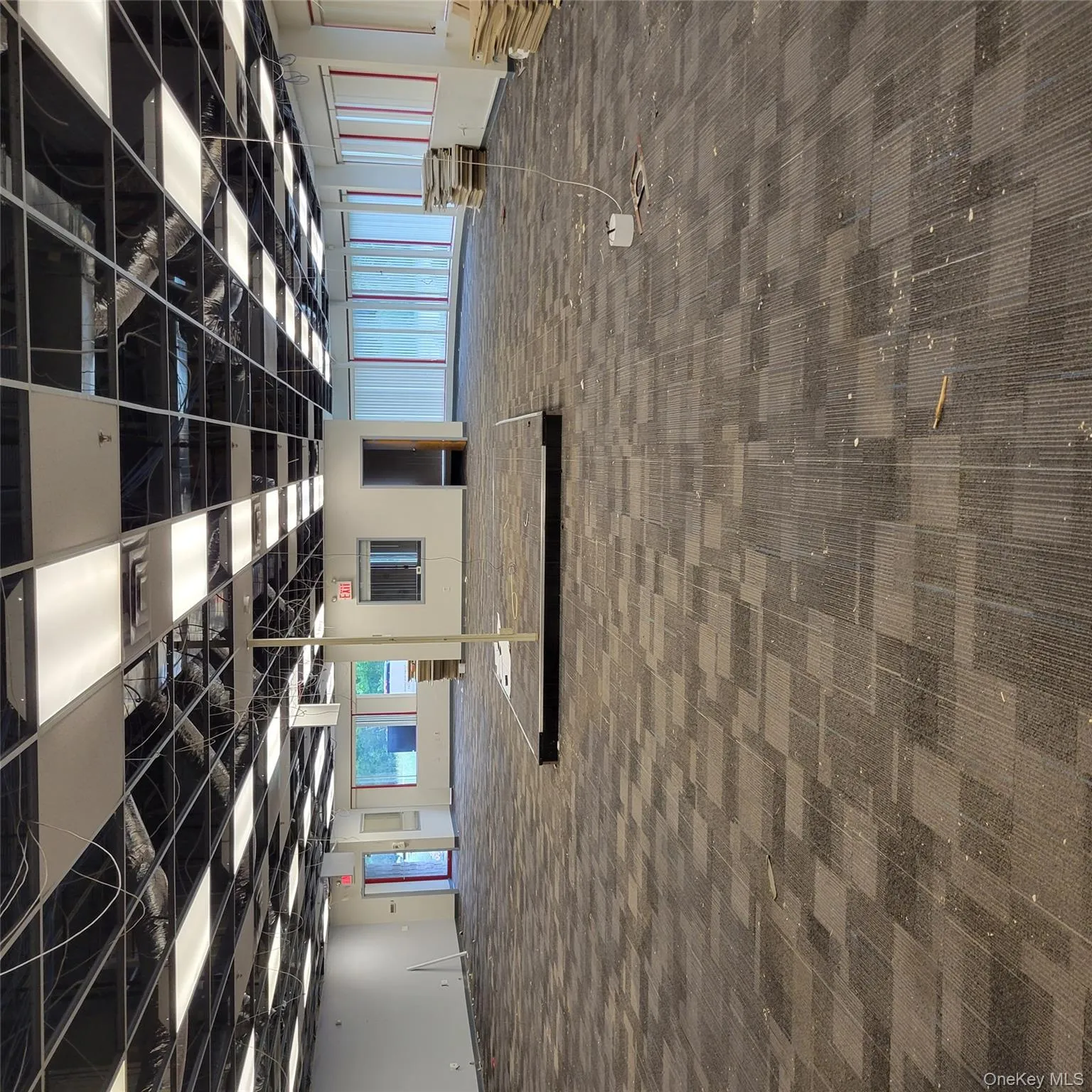 Miscellaneous room featuring dark colored carpet Miscellaneous room featuring dark colored carpet