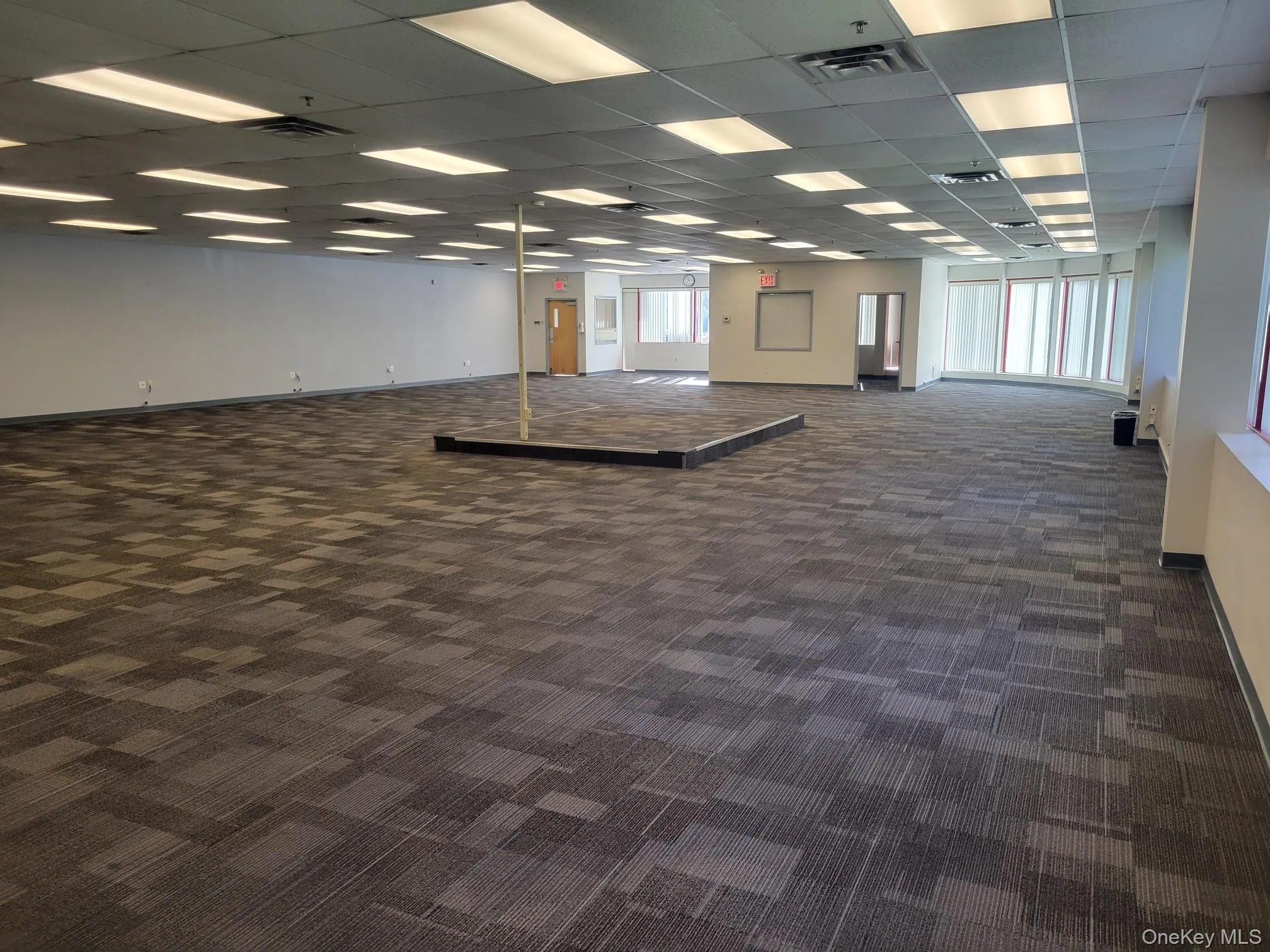 Spare room with dark carpet and a drop ceiling Spare room with dark carpet and a drop ceiling