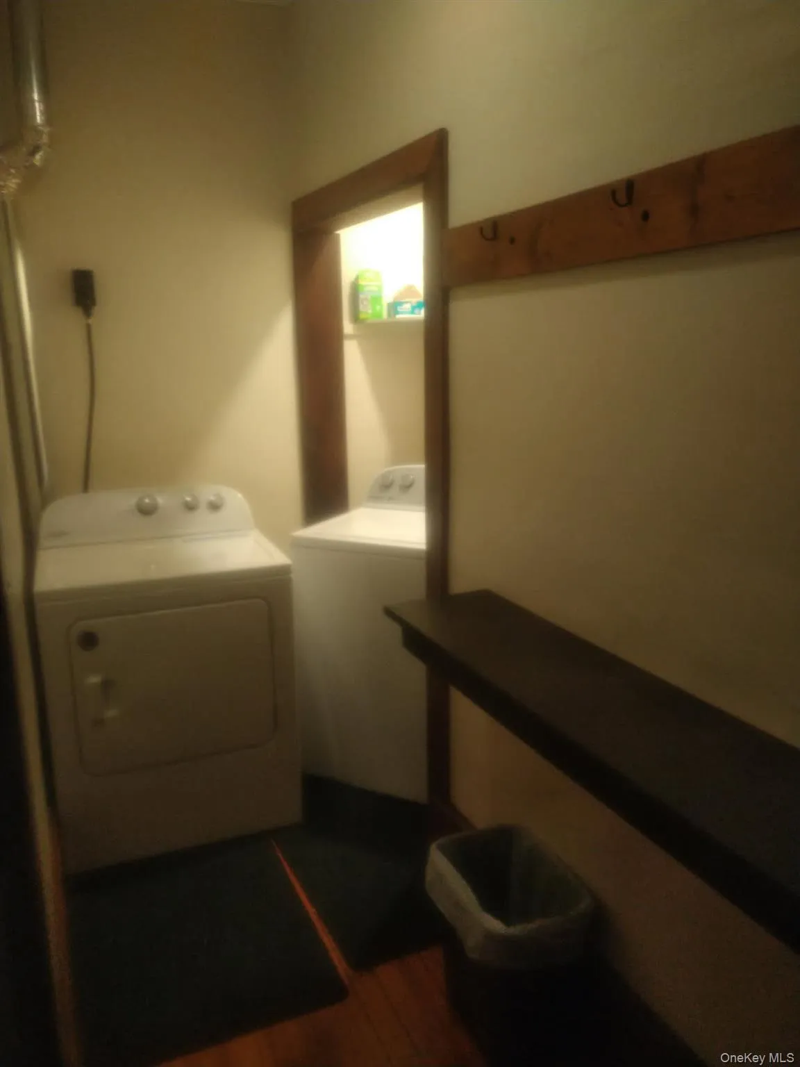 Laundry room with washer and clothes dryer and dark wood-style flooring Laundry room with washer and clothes dryer and dark wood-style flooring