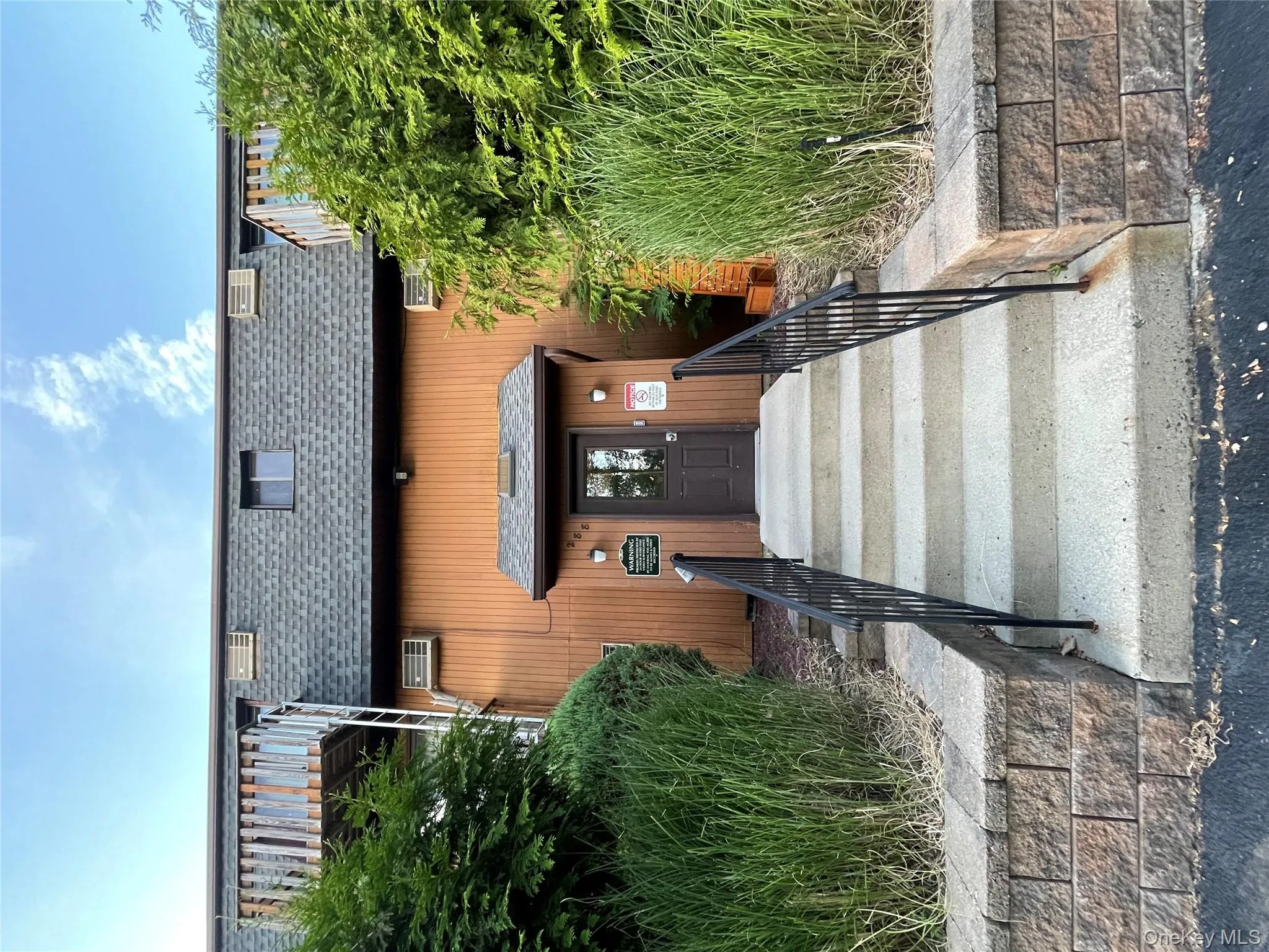 Entrance to property featuring roof with shingles and mansard roof Entrance to property featuring roof with shingles and mansard roof