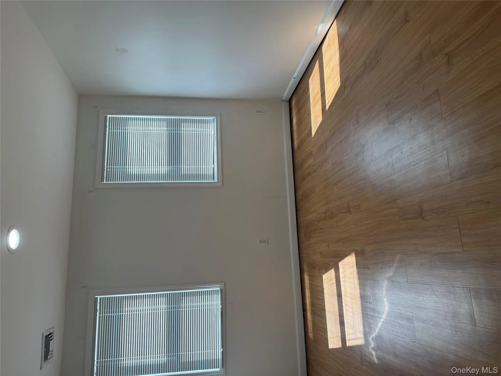 Unfurnished room featuring wood finished floors and recessed lighting Unfurnished room featuring wood finished floors and recessed lighting