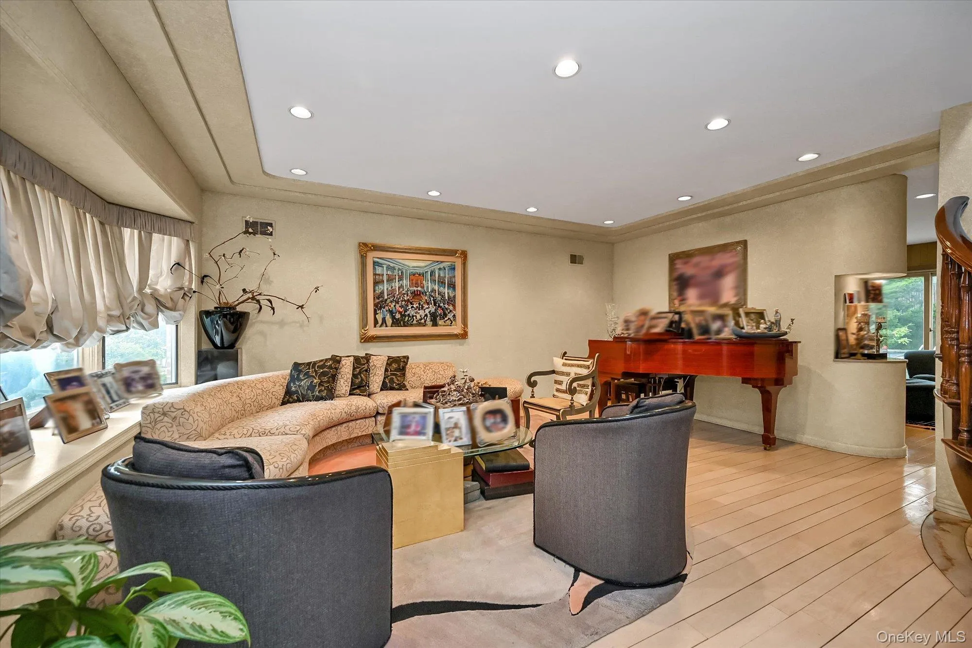 Living room featuring plenty of natural light, recessed lighting, and hardwood / wood-style floors Living room featuring plenty of natural light, recessed lighting, and hardwood / wood-style floors