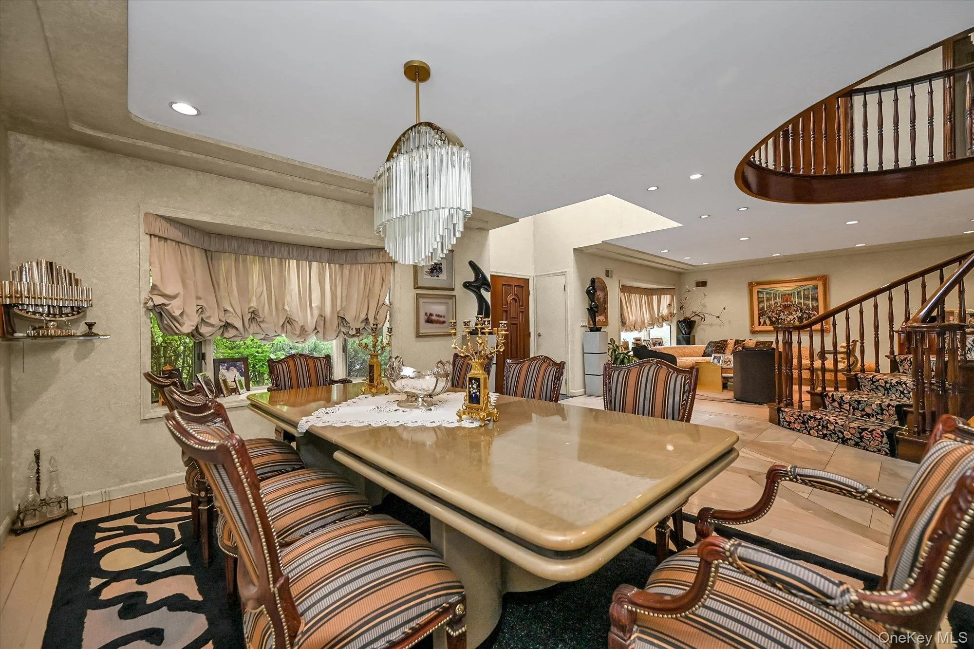 Dining room with recessed lighting, stairway, and light wood finished floors Dining room with recessed lighting, stairway, and light wood finished floors