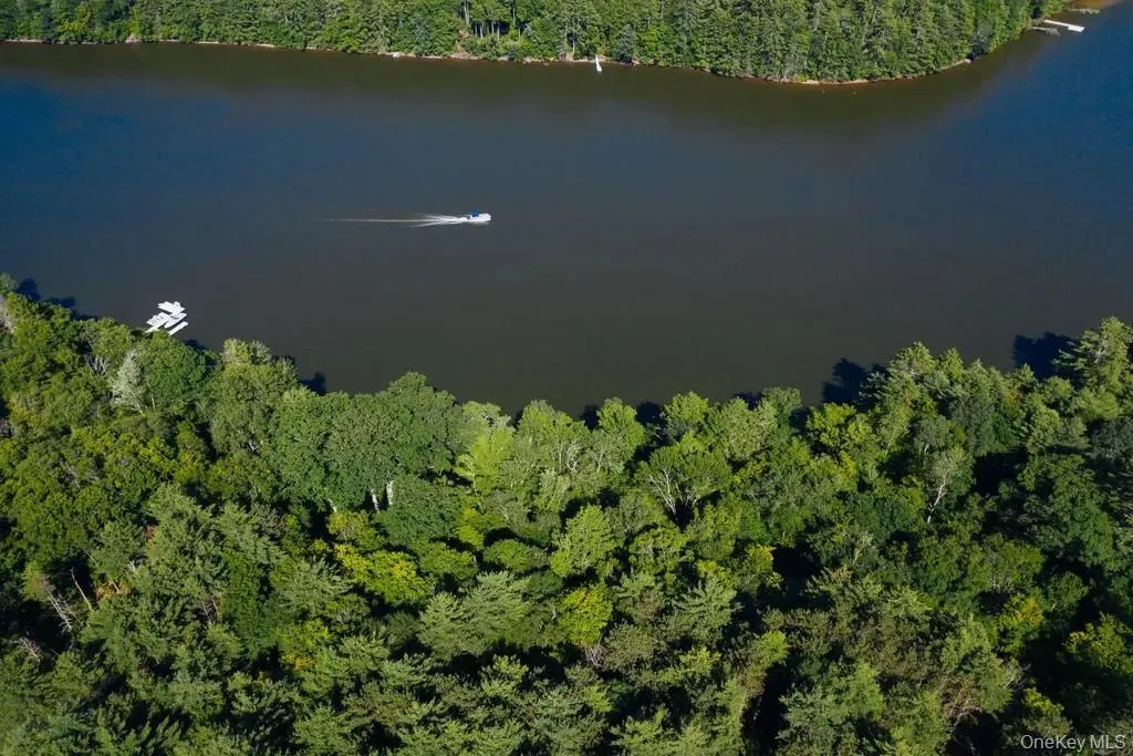 View of property location featuring a heavily wooded area and a large body of water View of property location featuring a heavily wooded area and a large body of water