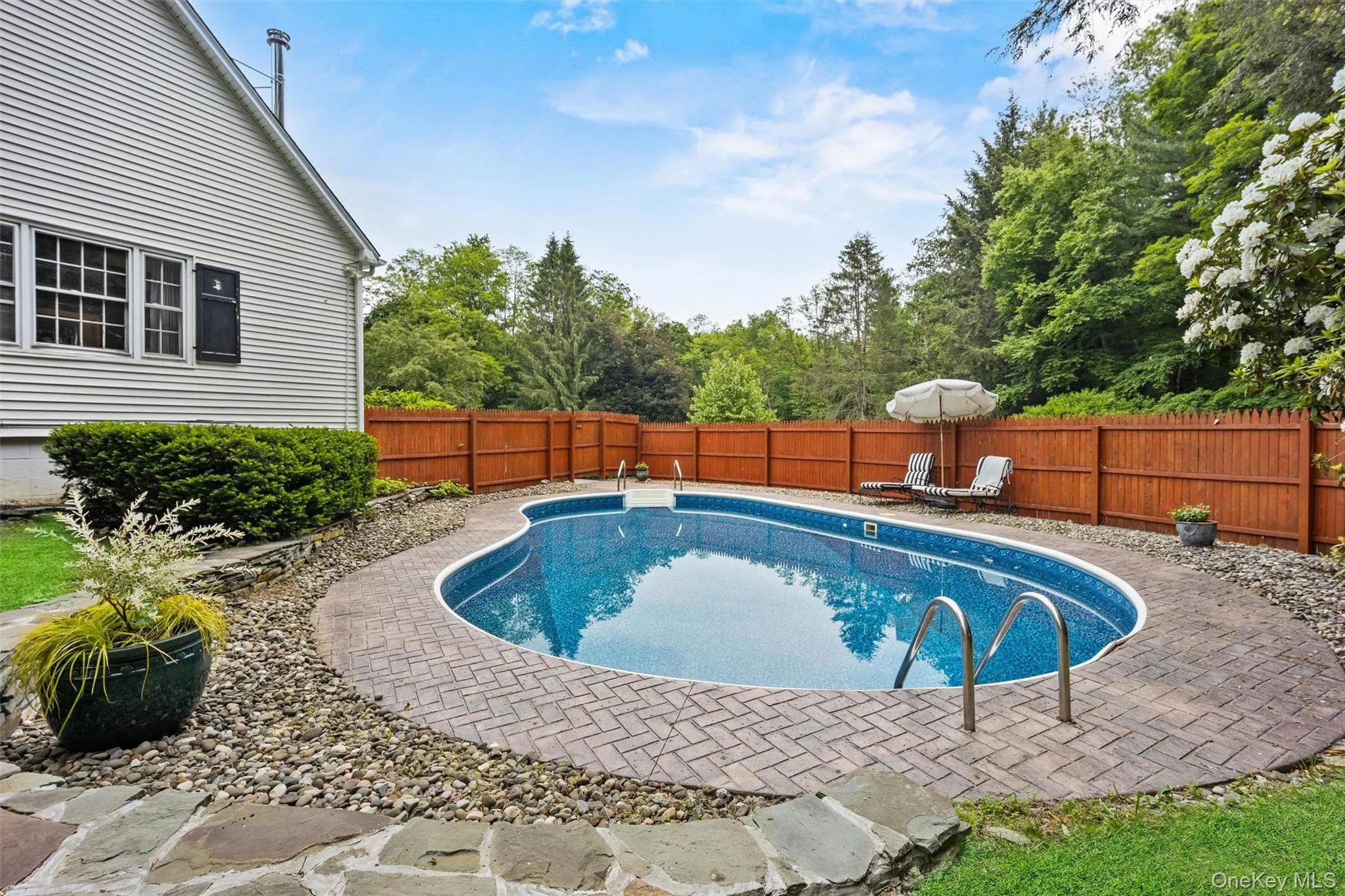 View of swimming pool featuring a fenced backyard and a patio View of swimming pool featuring a fenced backyard and a patio