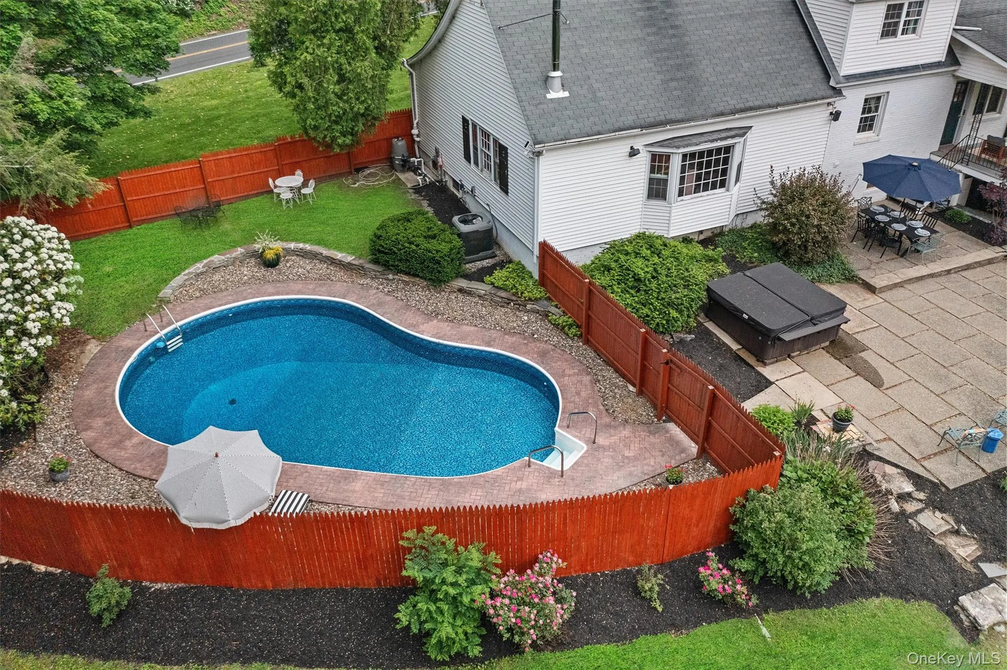 View of swimming pool with a patio, a fenced backyard, and outdoor dining area View of swimming pool with a patio, a fenced backyard, and outdoor dining area