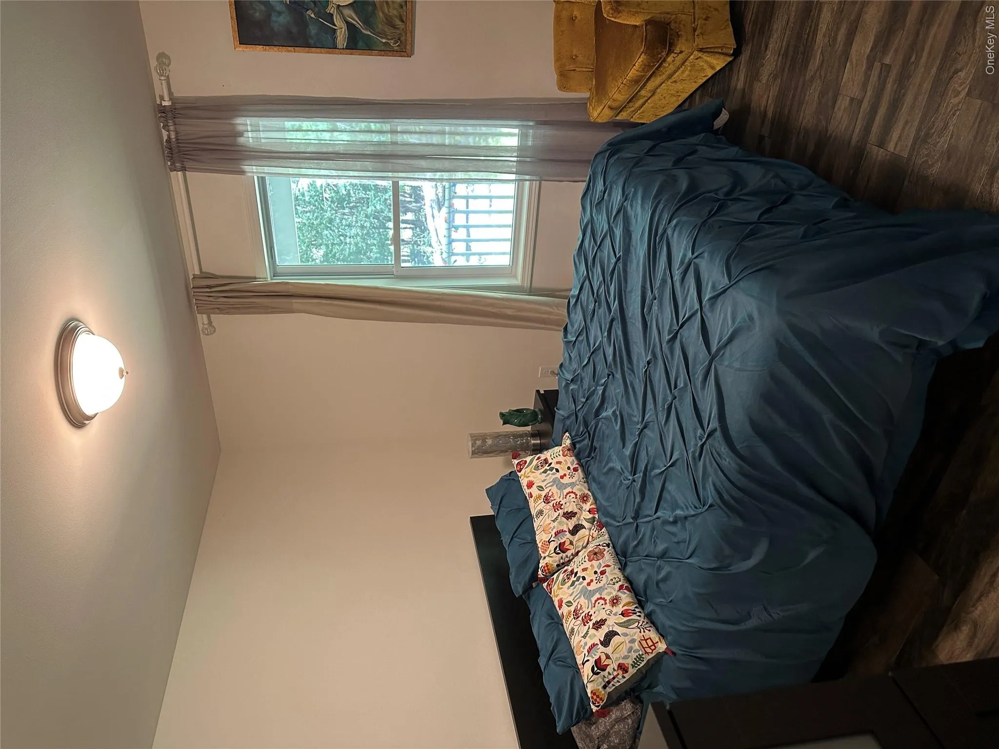 Bedroom with dark wood-style flooring Bedroom with dark wood-style flooring