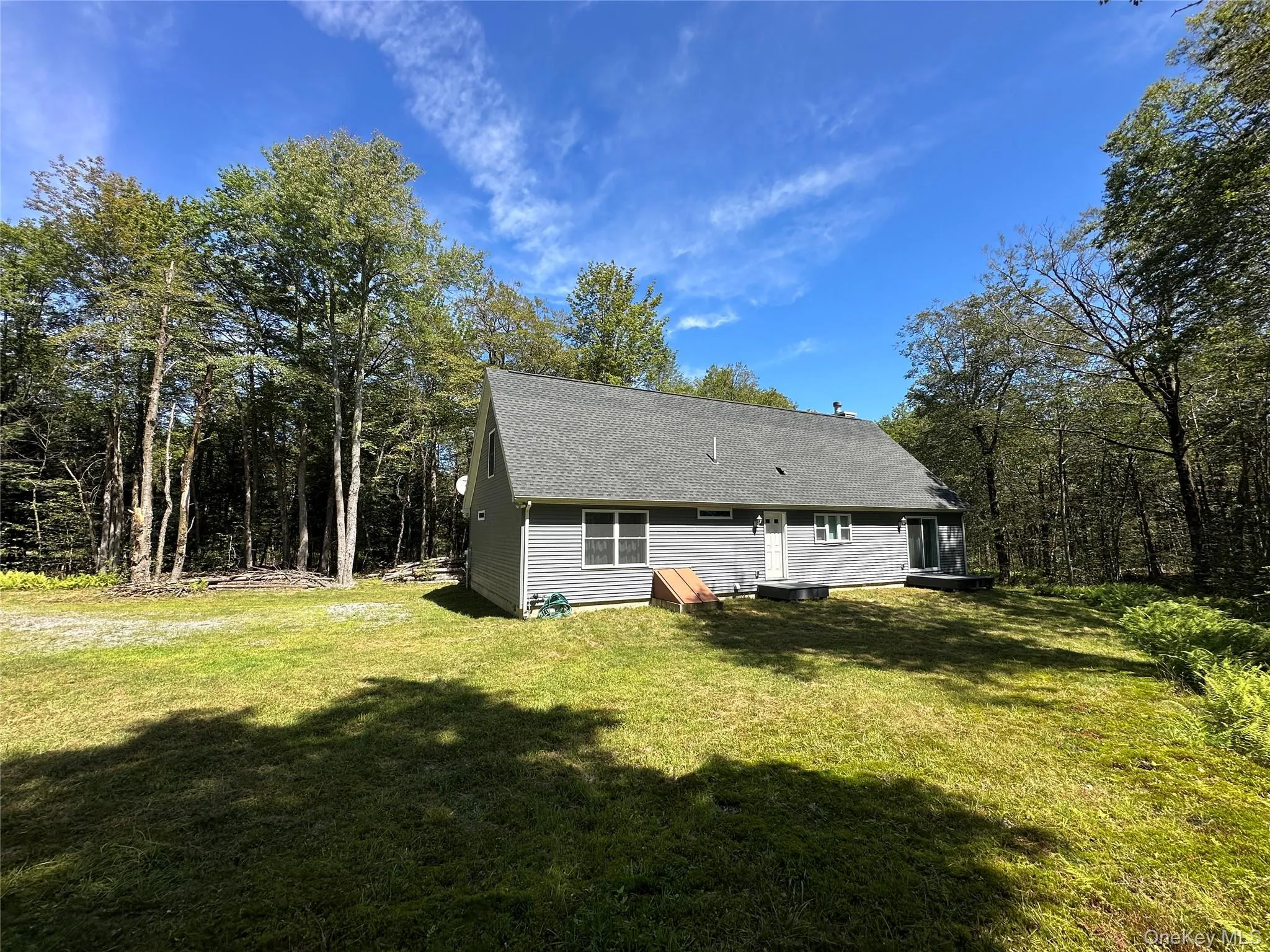 Back of property with a lawn and roof with shingles Back of property with a lawn and roof with shingles