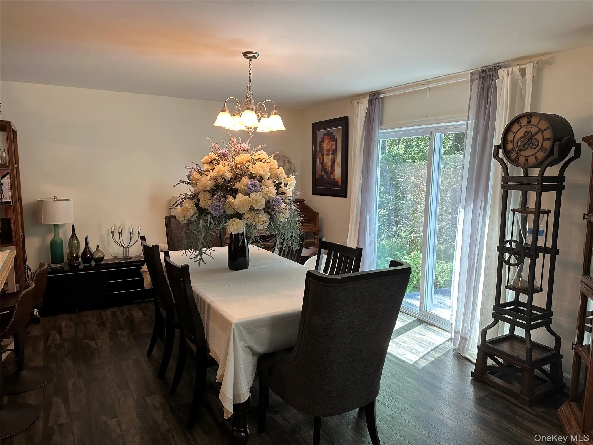 Dining room with dark wood finished floors and a chandelier Dining room with dark wood finished floors and a chandelier