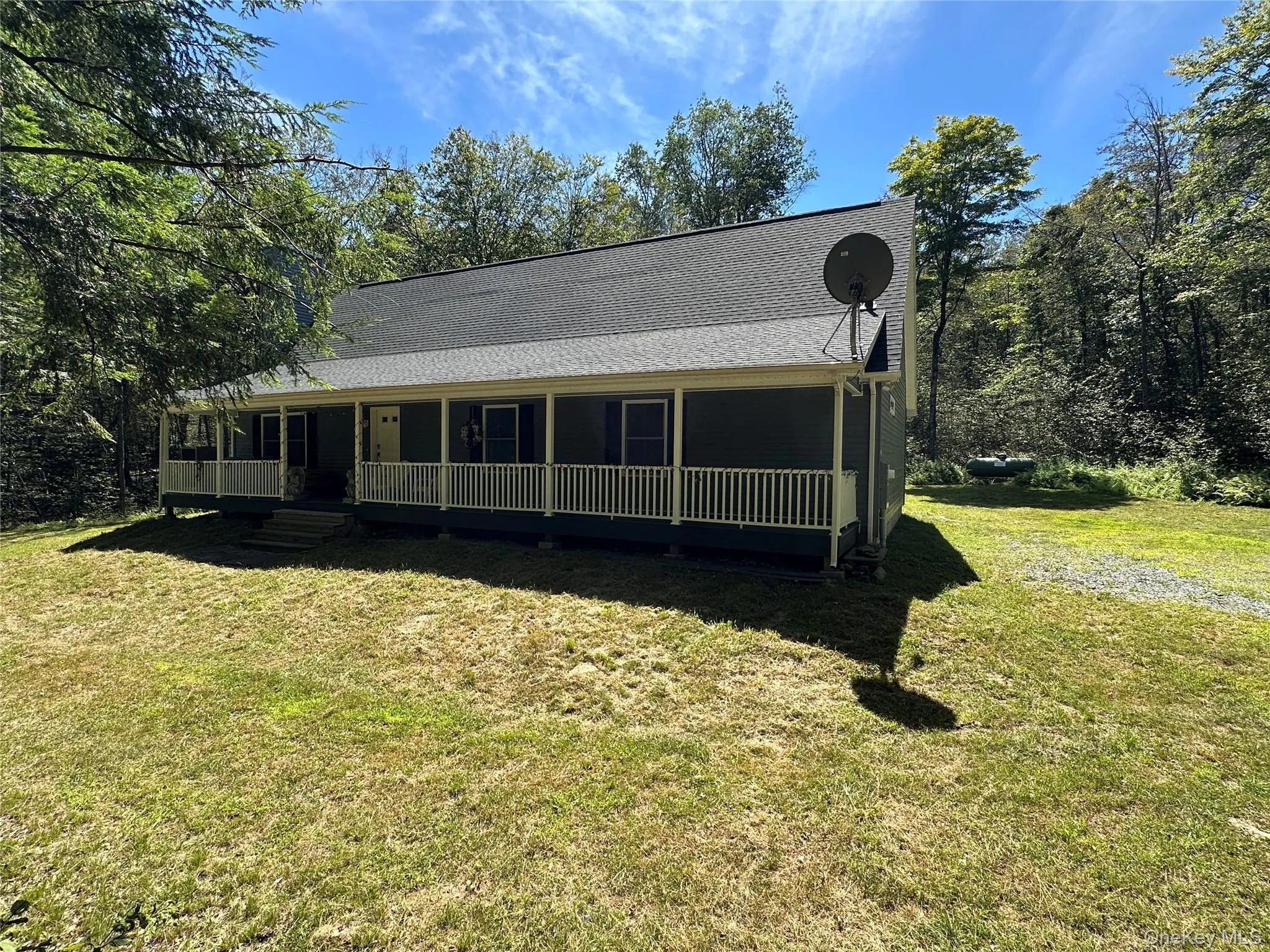 View of front of property featuring a front lawn, a porch, and roof with shingles View of front of property featuring a front lawn, a porch, and roof with shingles