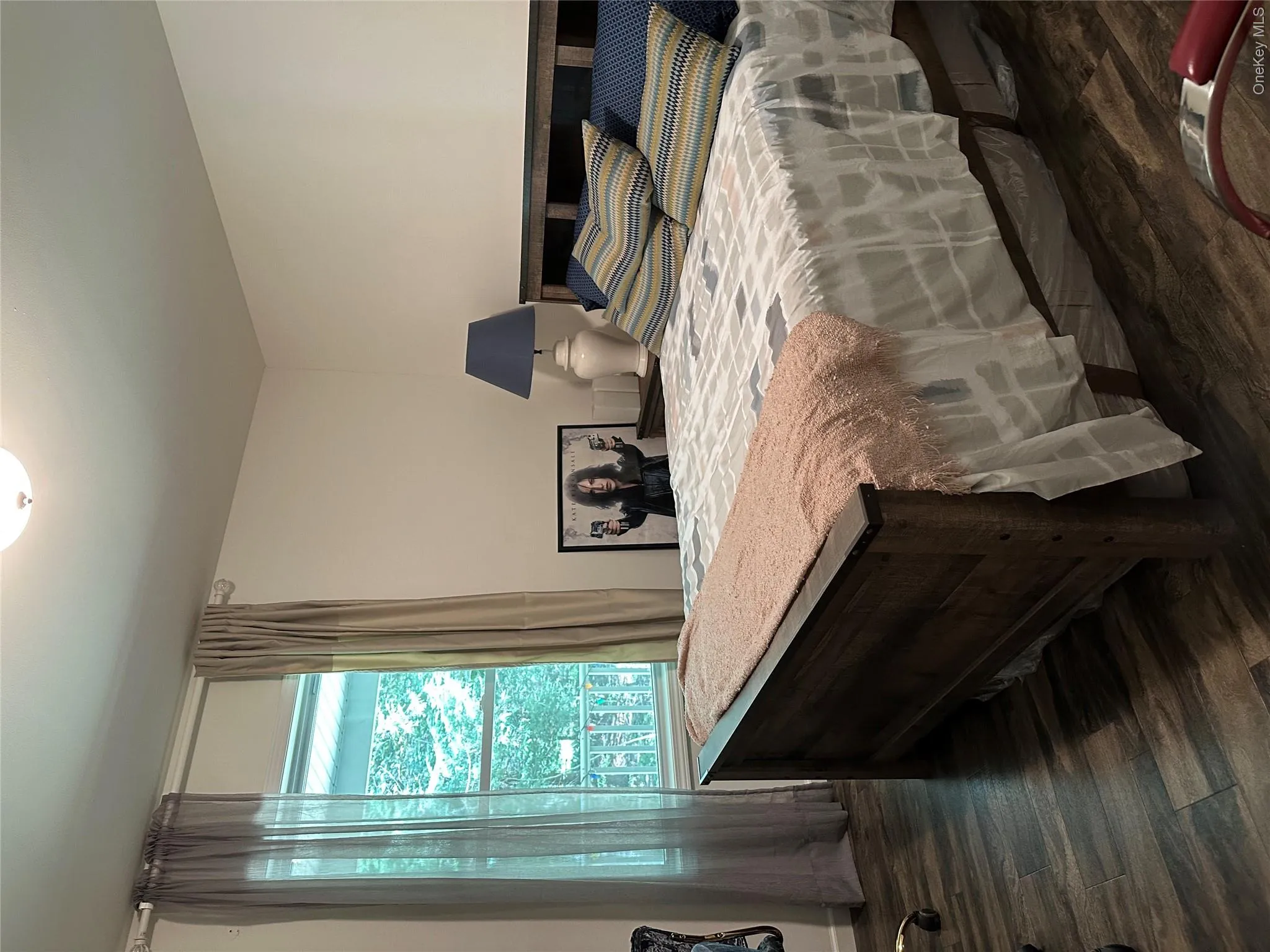 Bedroom with dark wood-style flooring Bedroom with dark wood-style flooring
