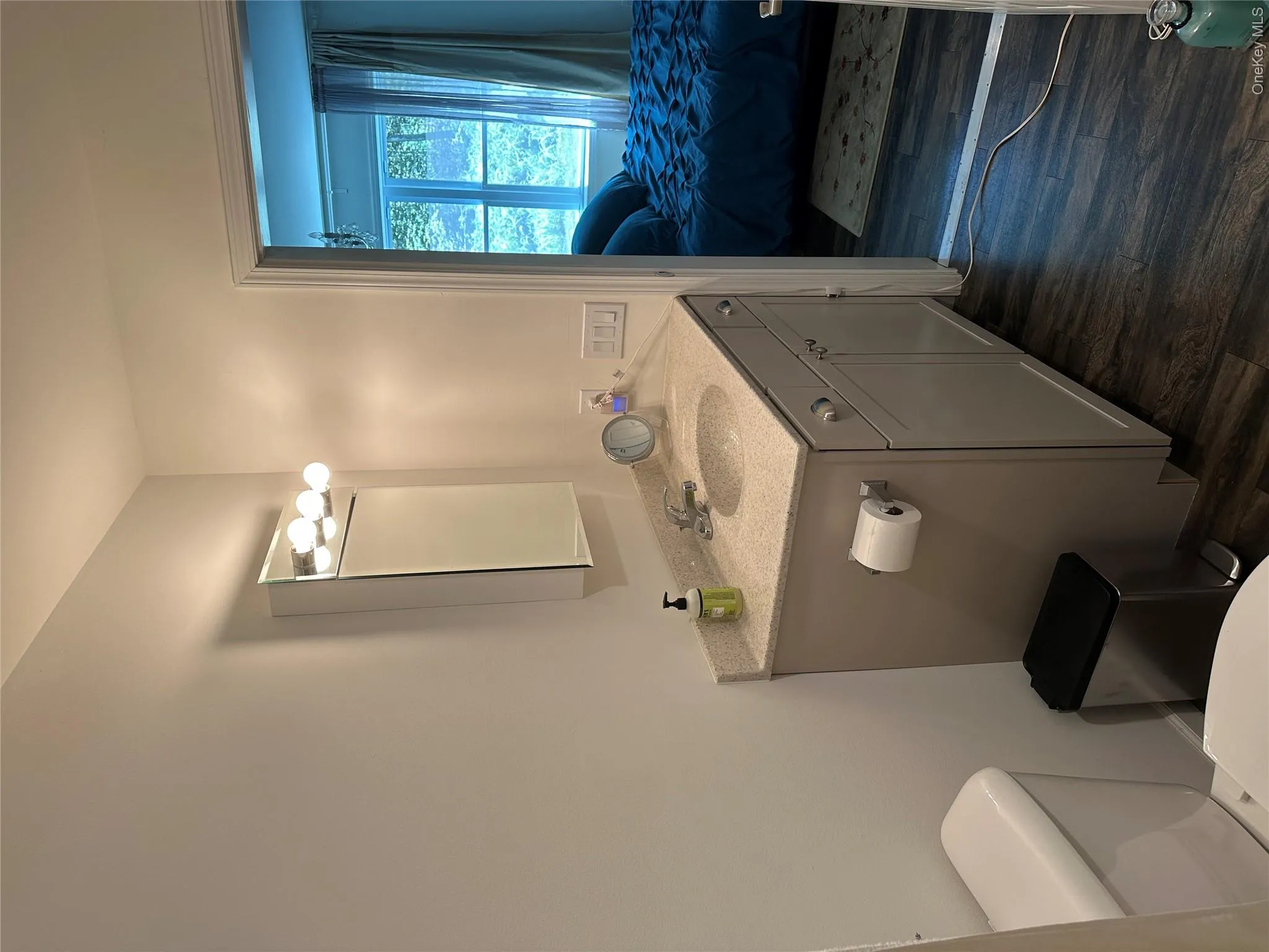 Half bathroom with vanity, dark wood-style floors, and connected bathroom Half bathroom with vanity, dark wood-style floors, and connected bathroom
