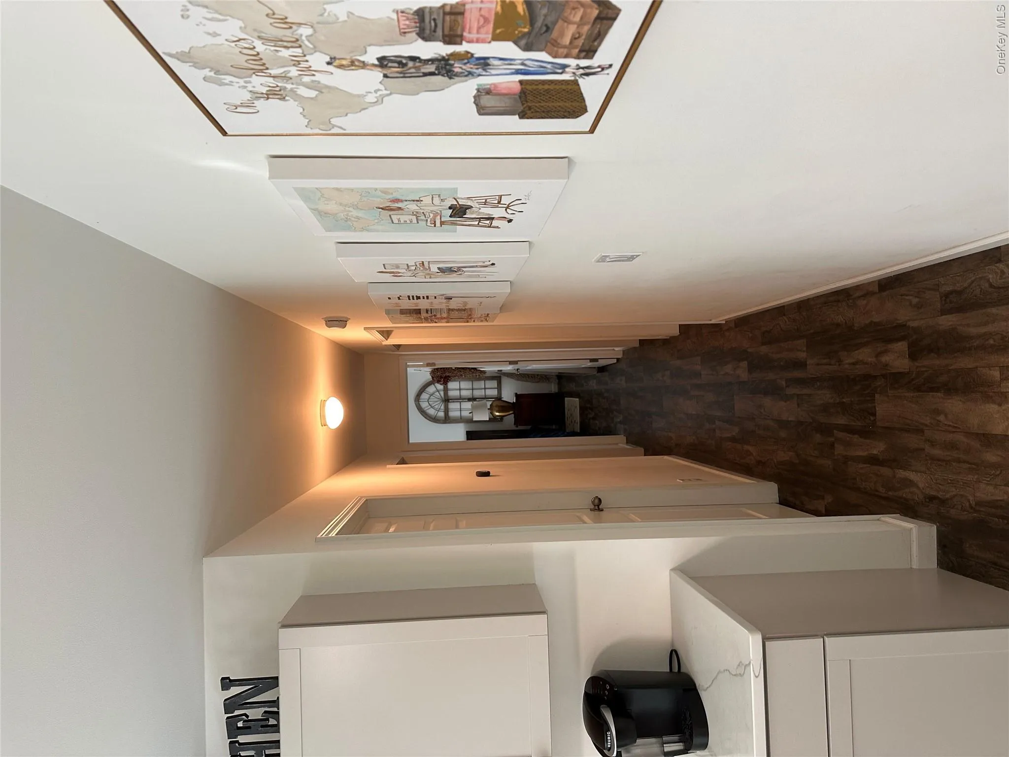 Hall featuring dark wood-type flooring and baseboards Hall featuring dark wood-type flooring and baseboards