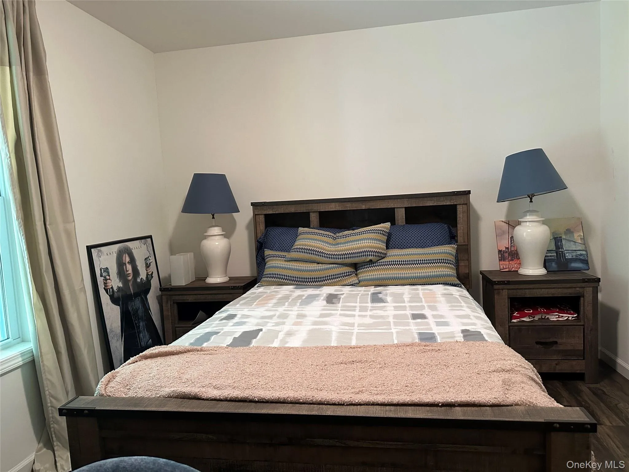 Bedroom featuring baseboards and dark wood finished floors Bedroom featuring baseboards and dark wood finished floors