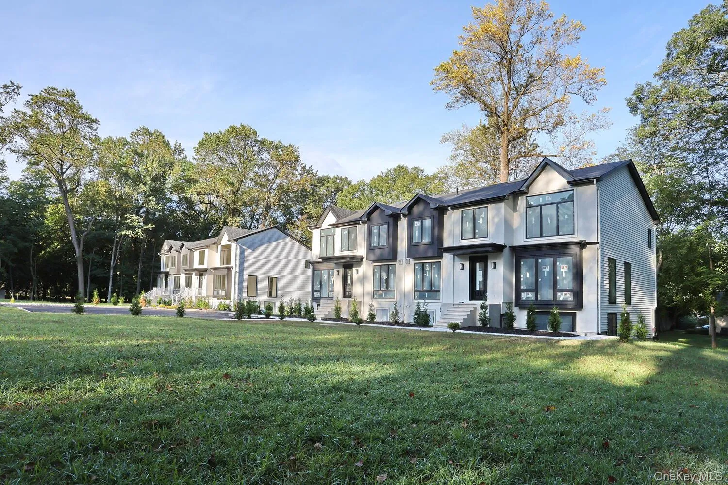 View of front of home with a front yard, stucco siding, and a residential view View of front of home with a front yard, stucco siding, and a residential view