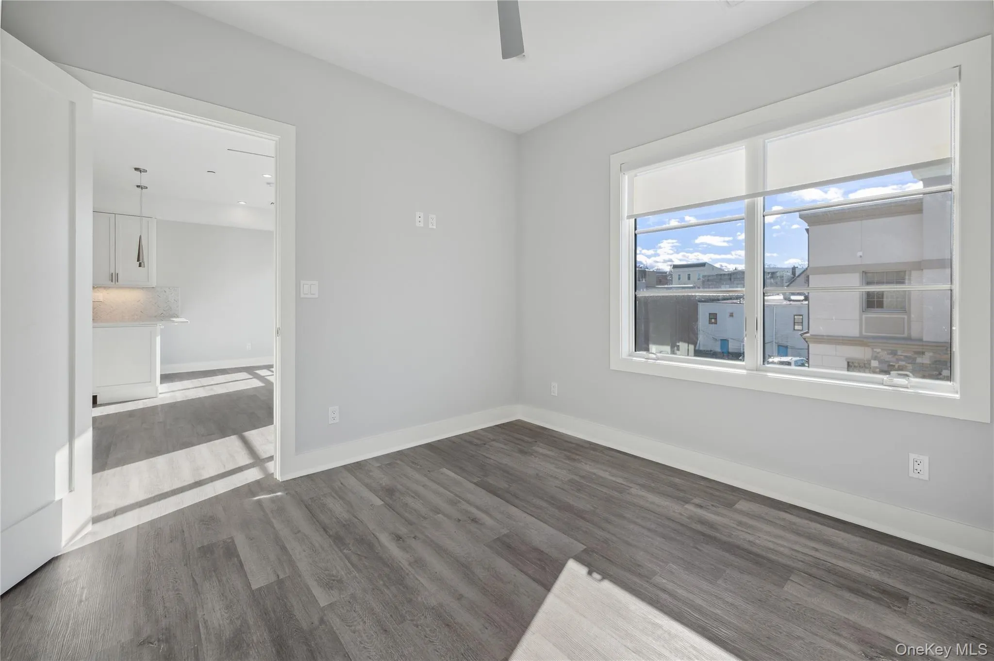 Spare room featuring light wood finished floors and a ceiling fan Spare room featuring light wood finished floors and a ceiling fan