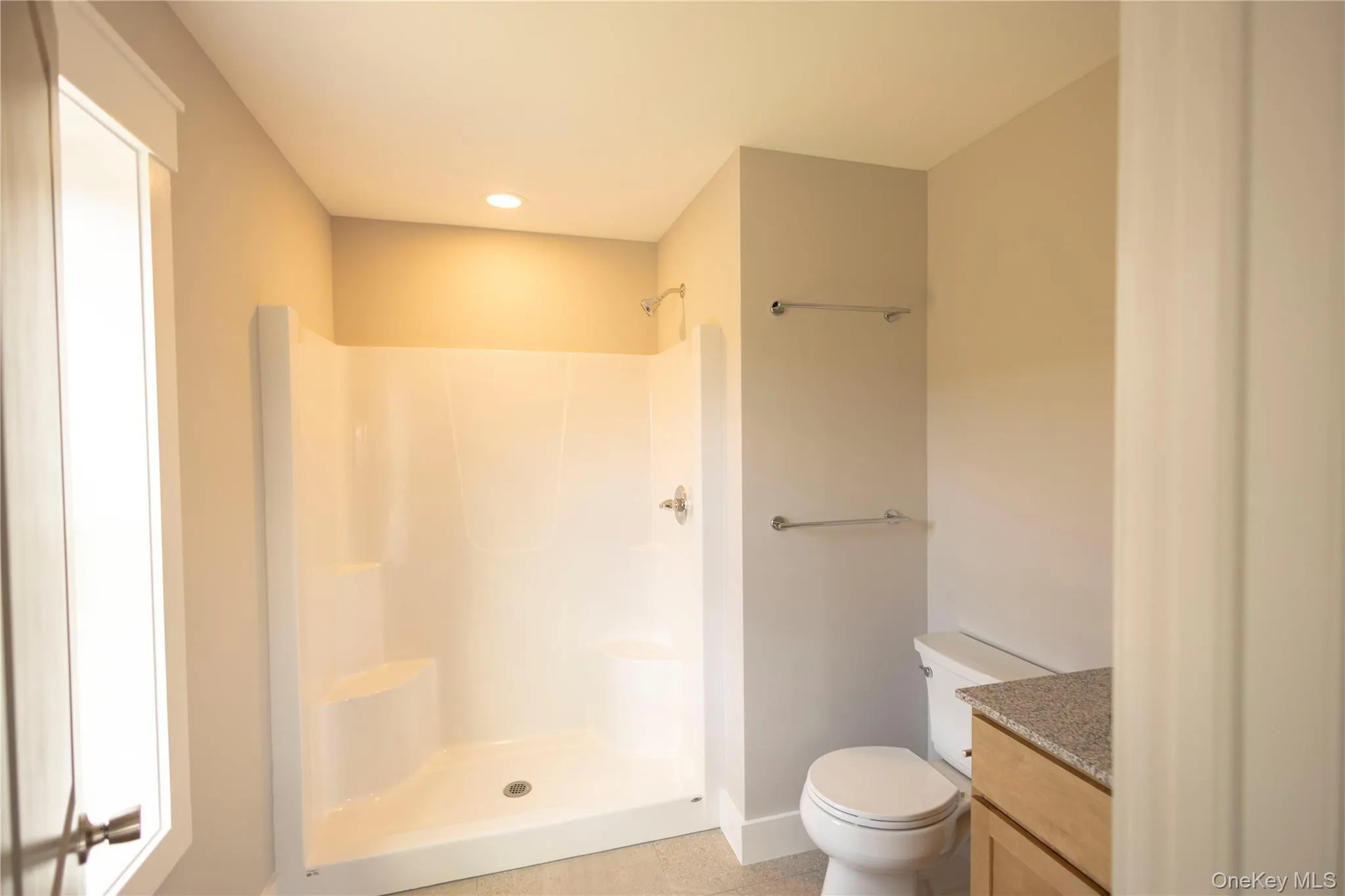 Bathroom with vanity, a shower, and recessed lighting Bathroom with vanity, a shower, and recessed lighting
