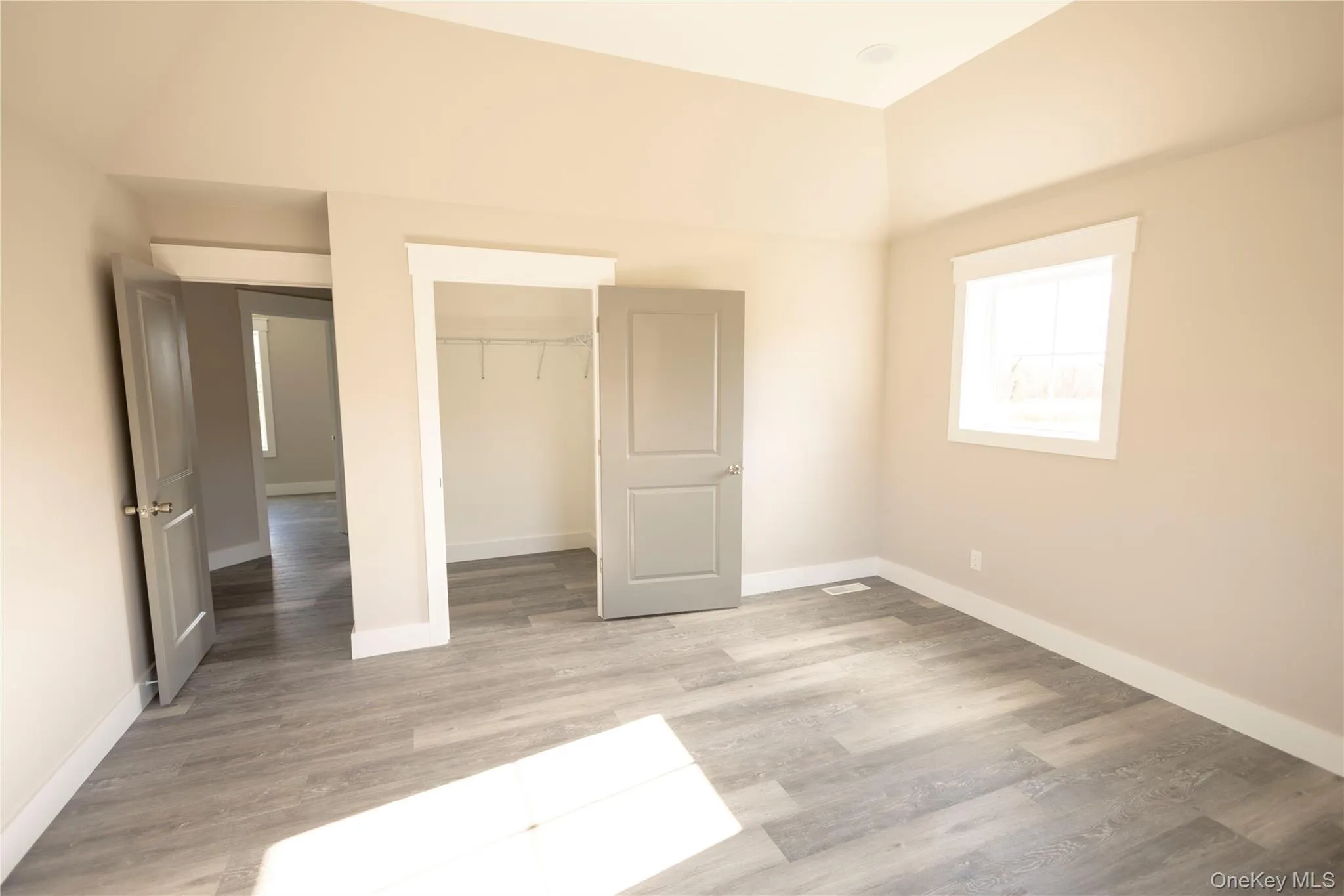 Unfurnished bedroom with light wood-style flooring and a closet Unfurnished bedroom with light wood-style flooring and a closet
