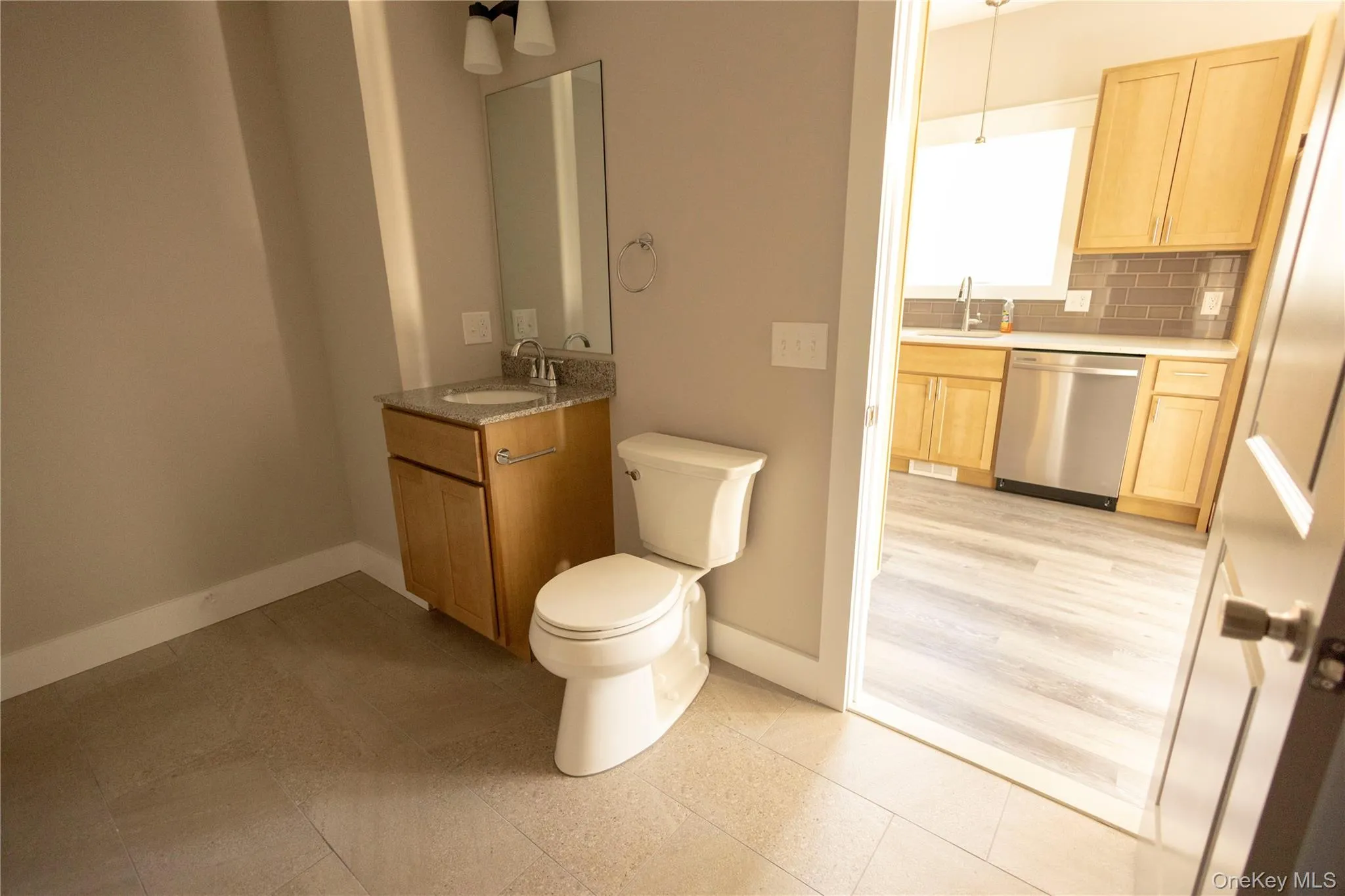 Bathroom featuring vanity and backsplash Bathroom featuring vanity and backsplash