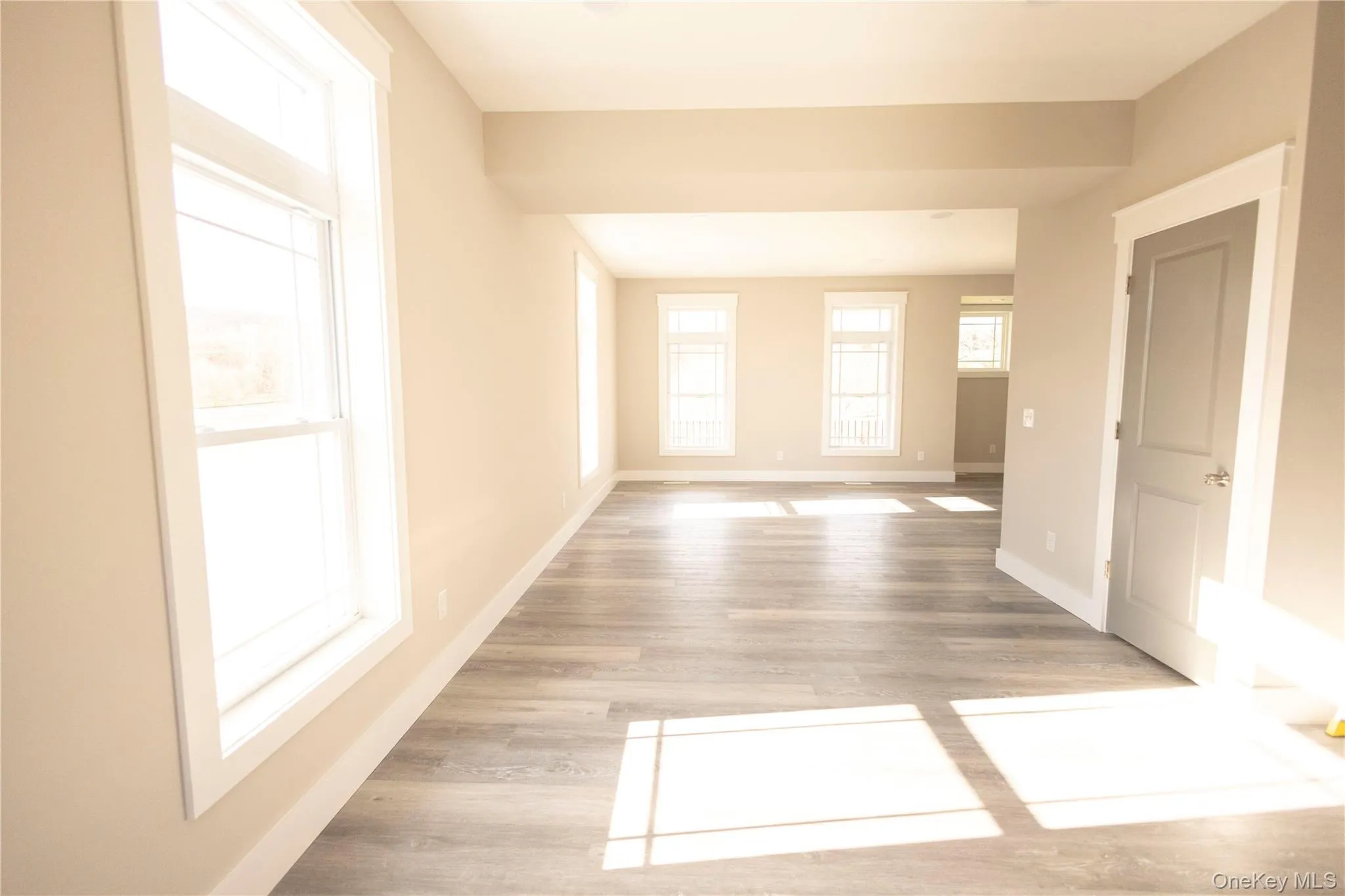 Empty room with light wood-style flooring and baseboards Empty room with light wood-style flooring and baseboards