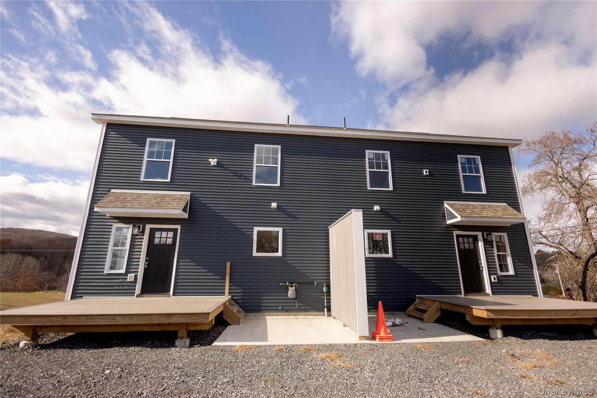 Back of property with a deck and roof with shingles Back of property with a deck and roof with shingles