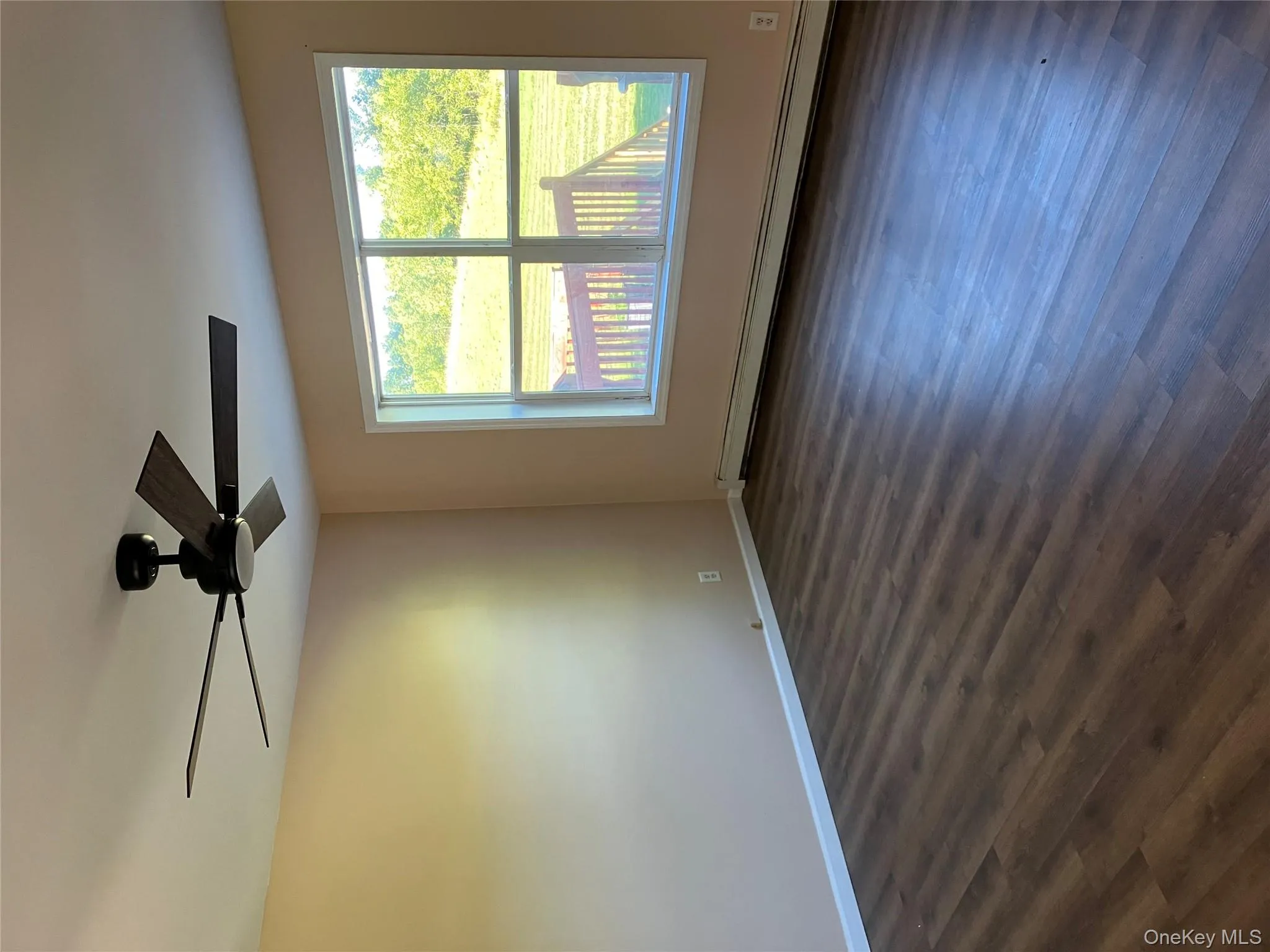 Spare room with a baseboard heating unit, dark wood-style flooring, and a ceiling fan Spare room with a baseboard heating unit, dark wood-style flooring, and a ceiling fan