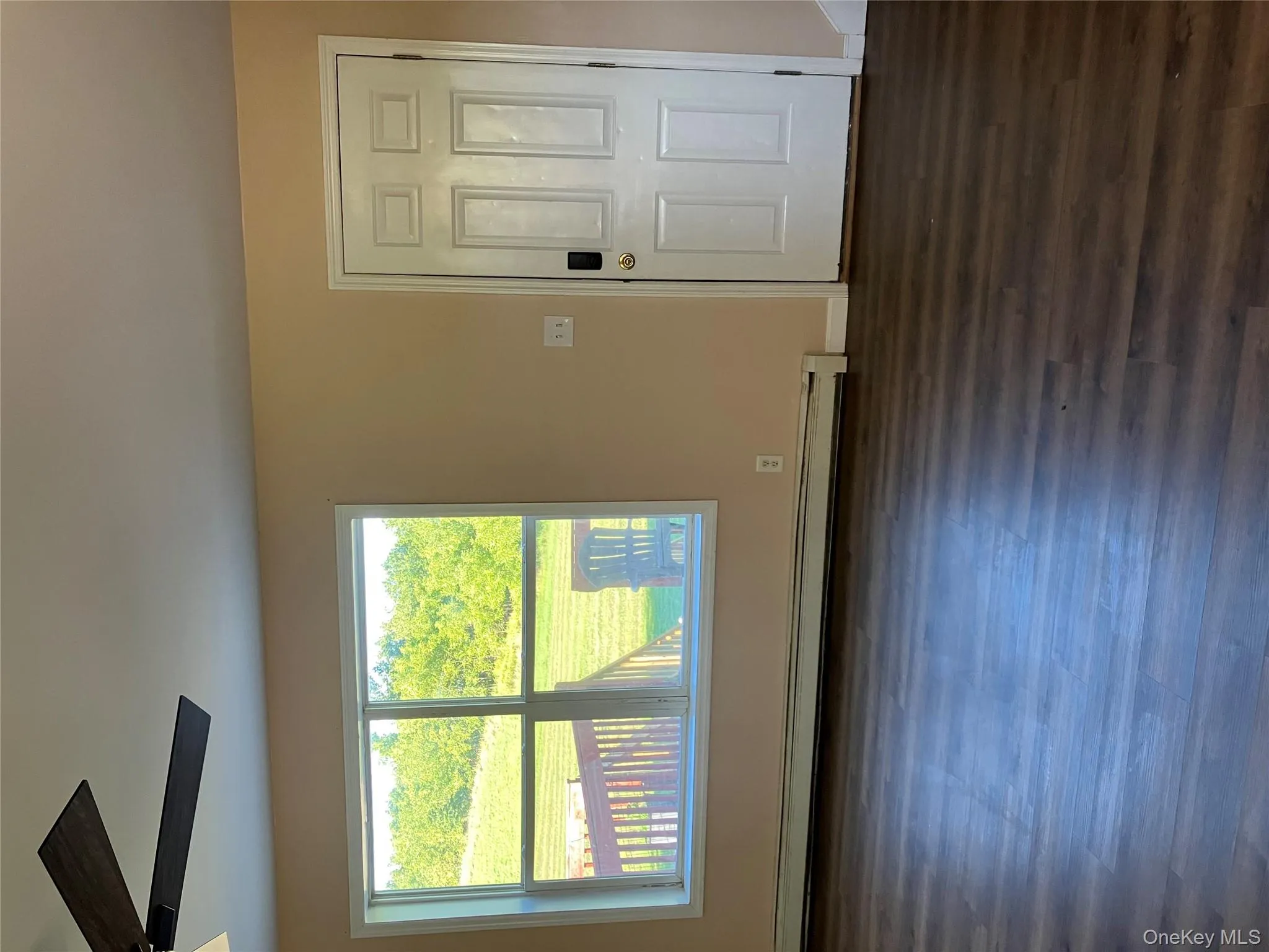 Entryway featuring dark wood-style floors and a baseboard radiator Entryway featuring dark wood-style floors and a baseboard radiator