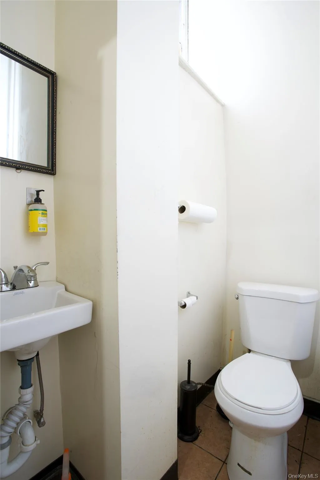 Half bathroom with tile patterned floors and toilet Half bathroom with tile patterned floors and toilet