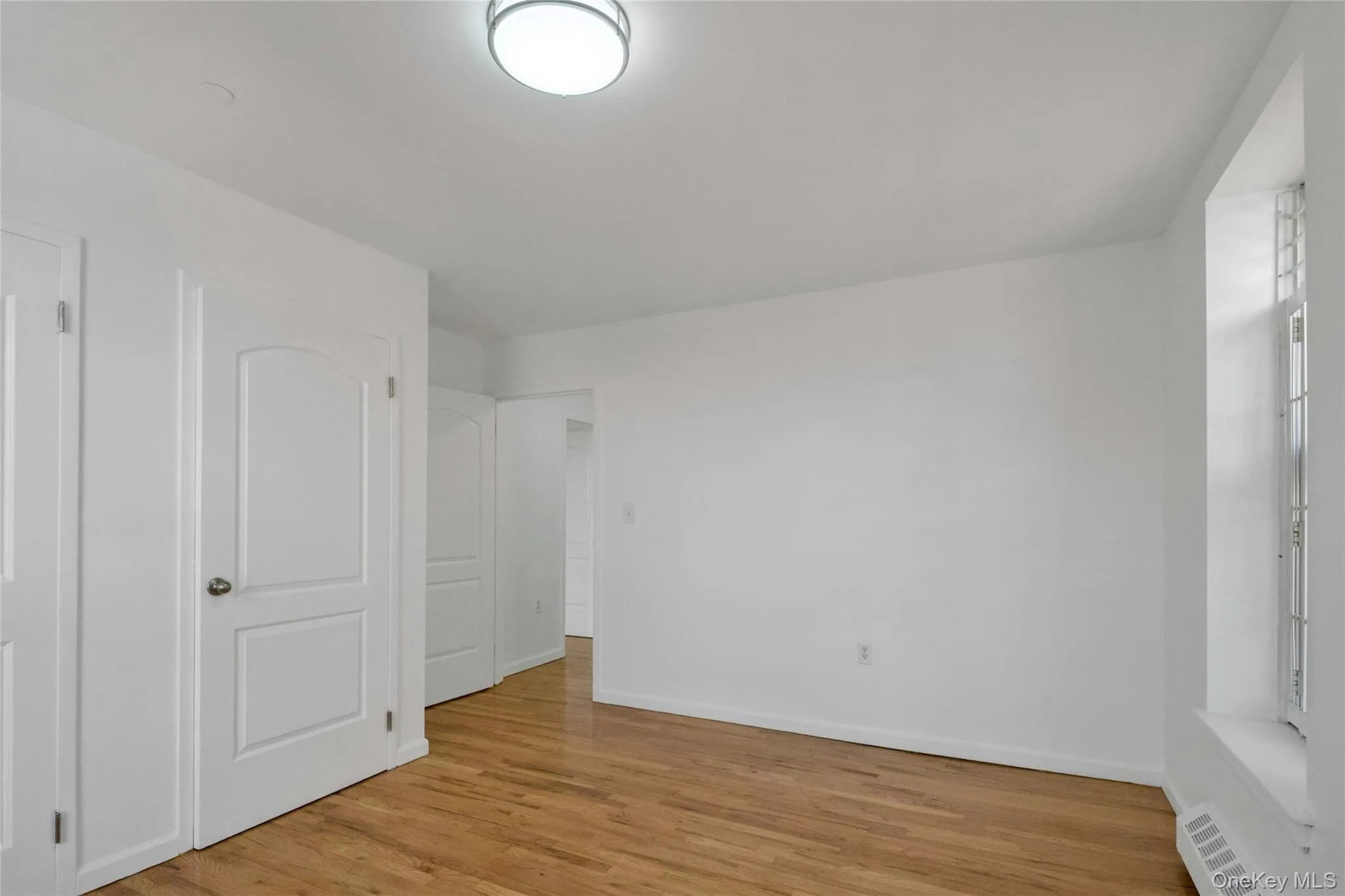 Unfurnished bedroom with baseboards and light wood finished floors Unfurnished bedroom with baseboards and light wood finished floors