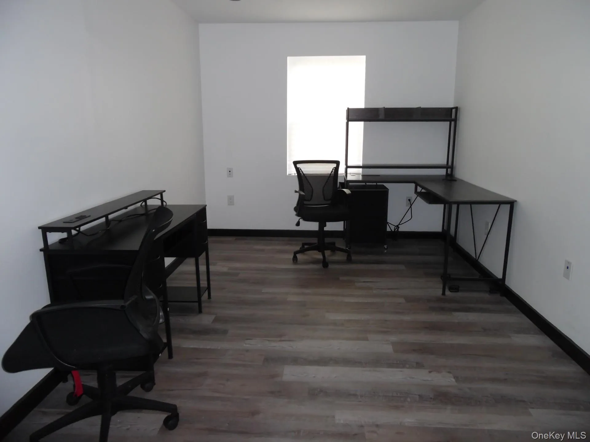 Office space with light wood-style floors and baseboards Office space with light wood-style floors and baseboards