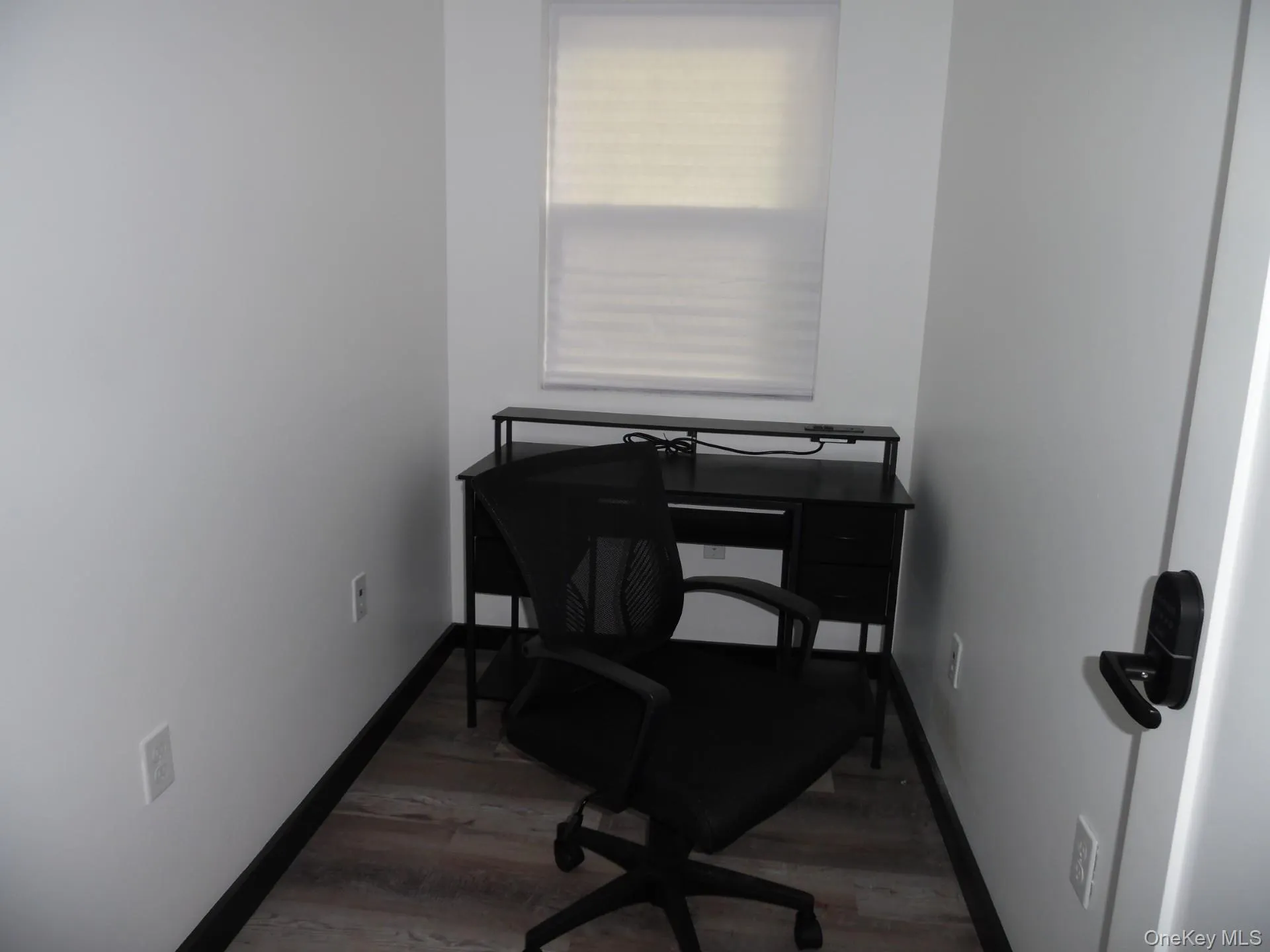 Office area with light wood-style floors Office area with light wood-style floors