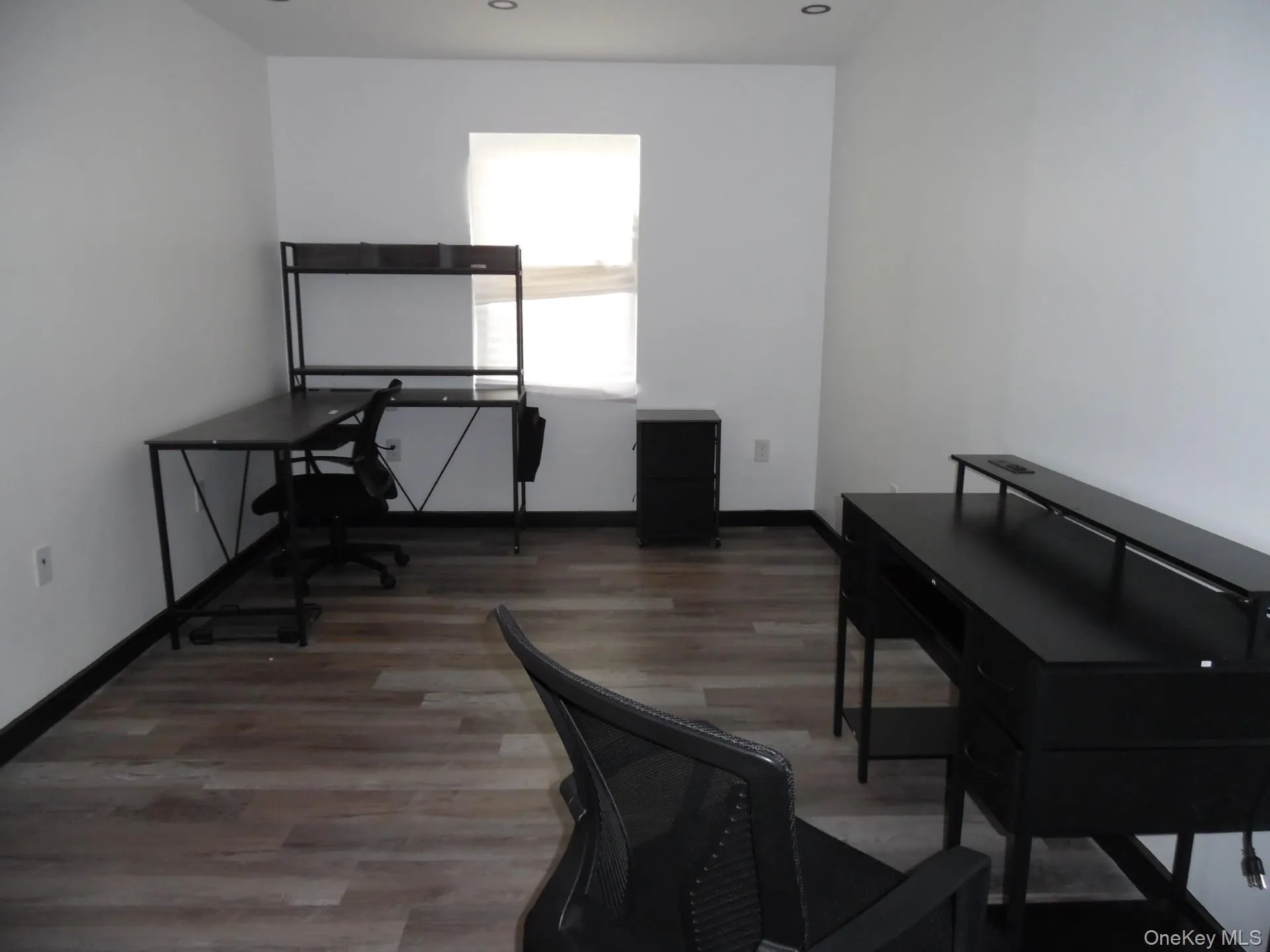 Home office featuring dark wood-style flooring Home office featuring dark wood-style flooring