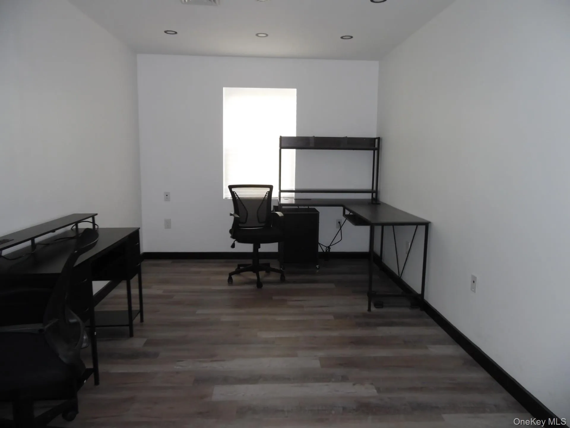 Office area with light wood finished floors and baseboards Office area with light wood finished floors and baseboards