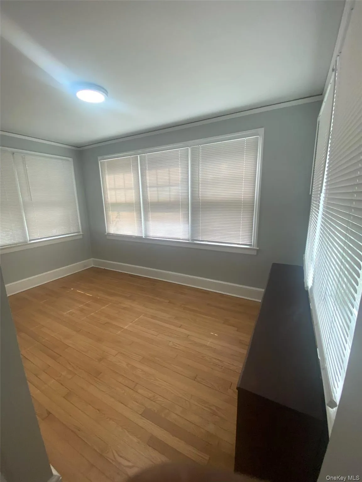 Spare room with baseboards and light wood-style floors Spare room with baseboards and light wood-style floors