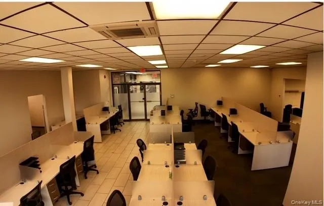 Recreation room with a drop ceiling and an office area Recreation room with a drop ceiling and an office area